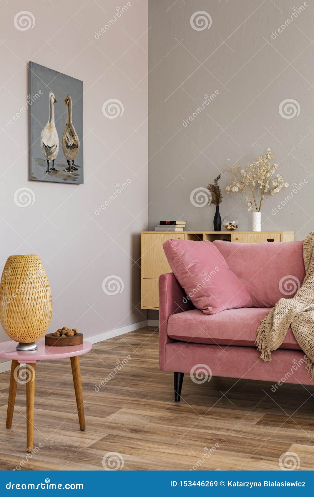 living room in neutral colors with accents of pink and wood