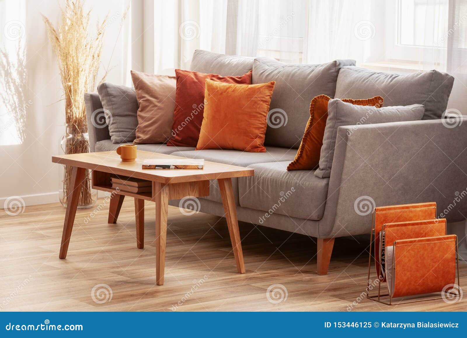 Grey couch top orange pillows