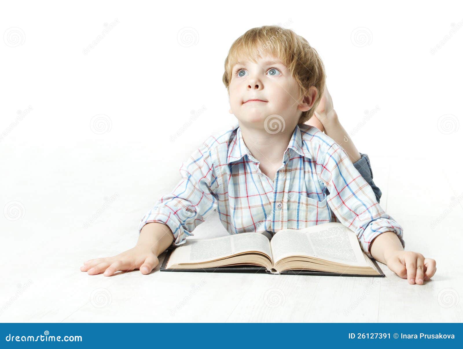 Llittle child reading book and dreaming. Llittle child reading book lying down on floor and dreaming