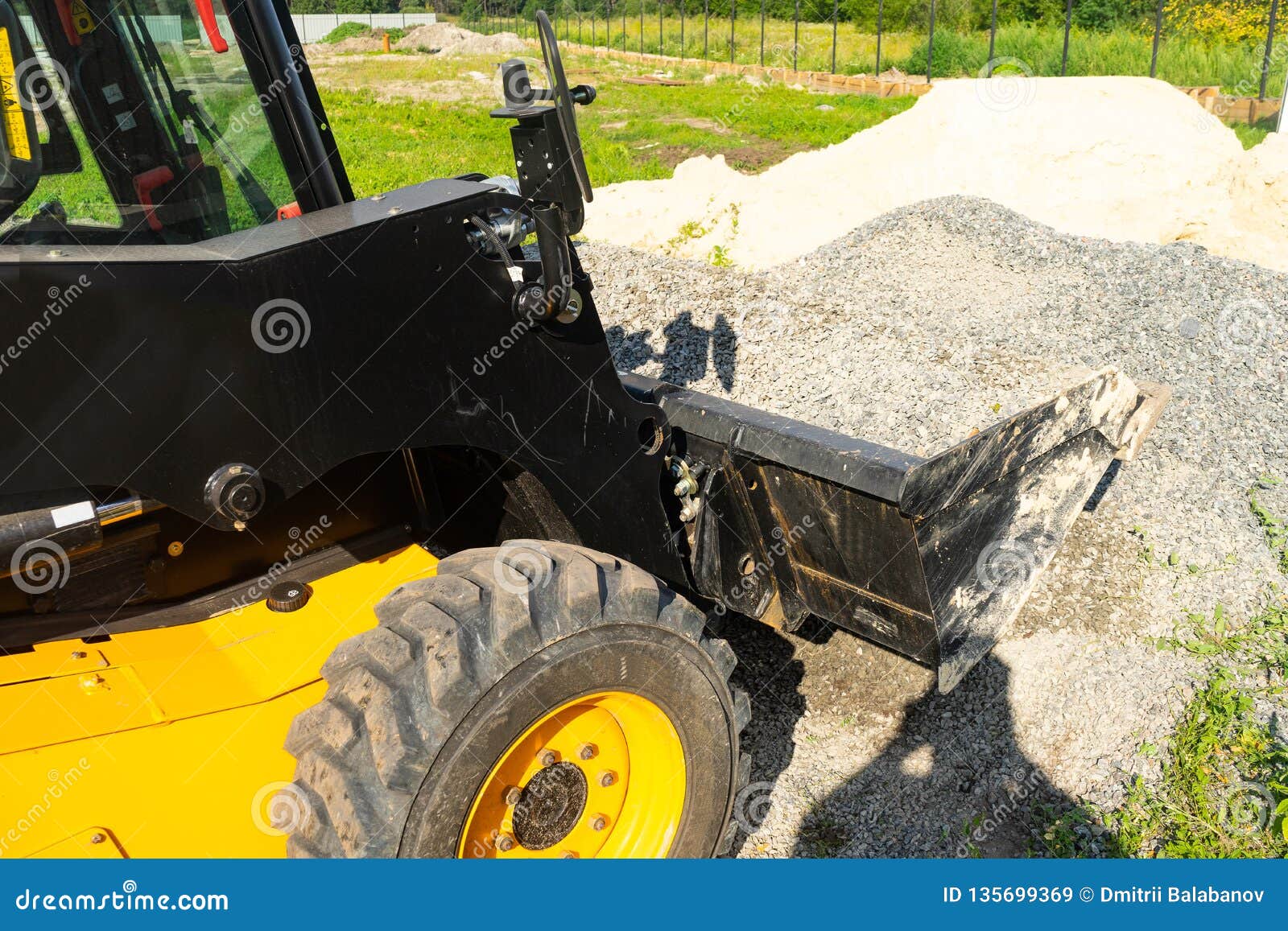 The Loader Picked Up Rubble in the Bucket for Construction Work. Stock