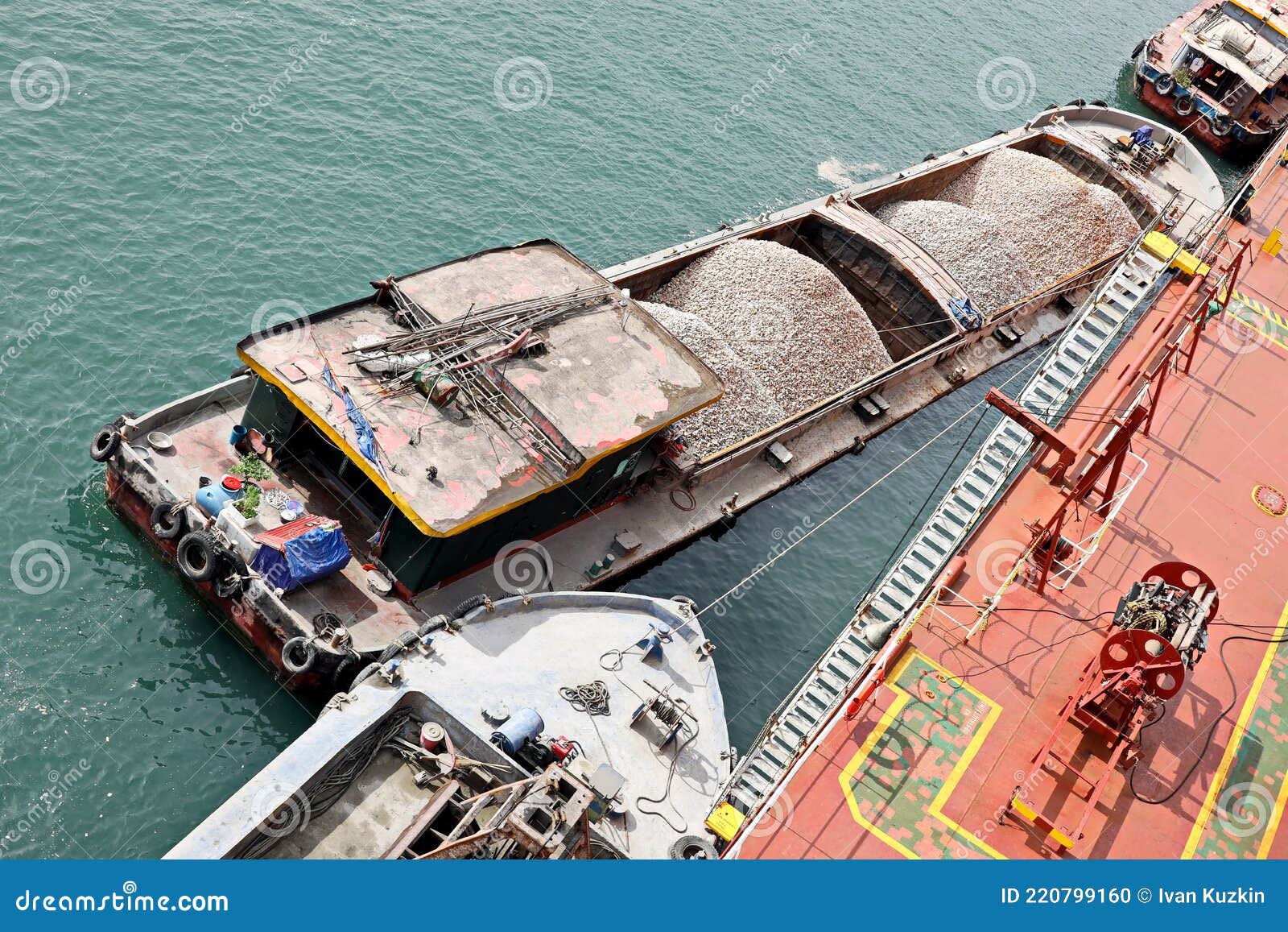 Loading Bulk Cargo of Limestone from Barges into a Bulk Carrier by