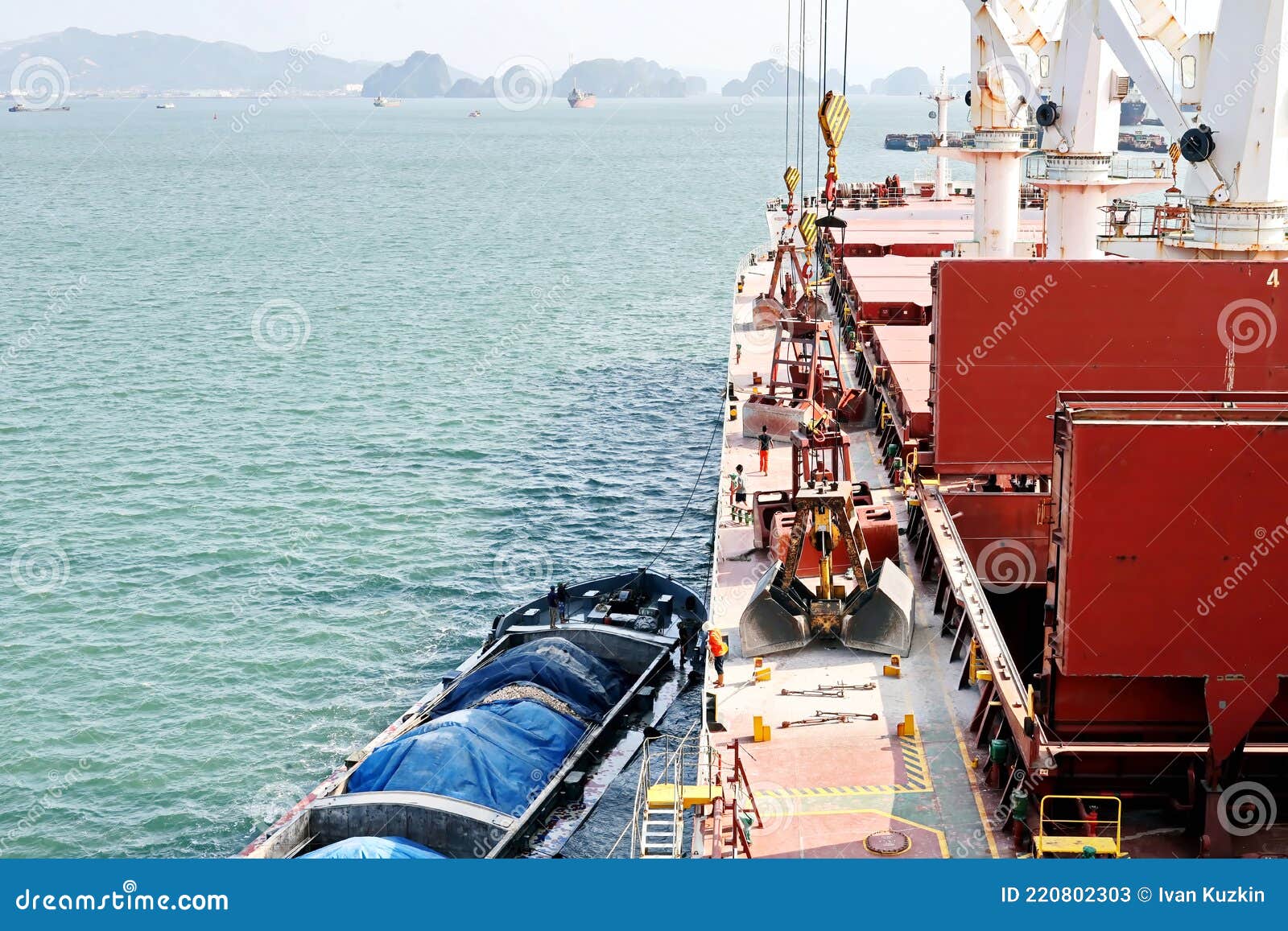 Loading Bulk Cargo of Limestone from Barges into a Bulk Carrier by
