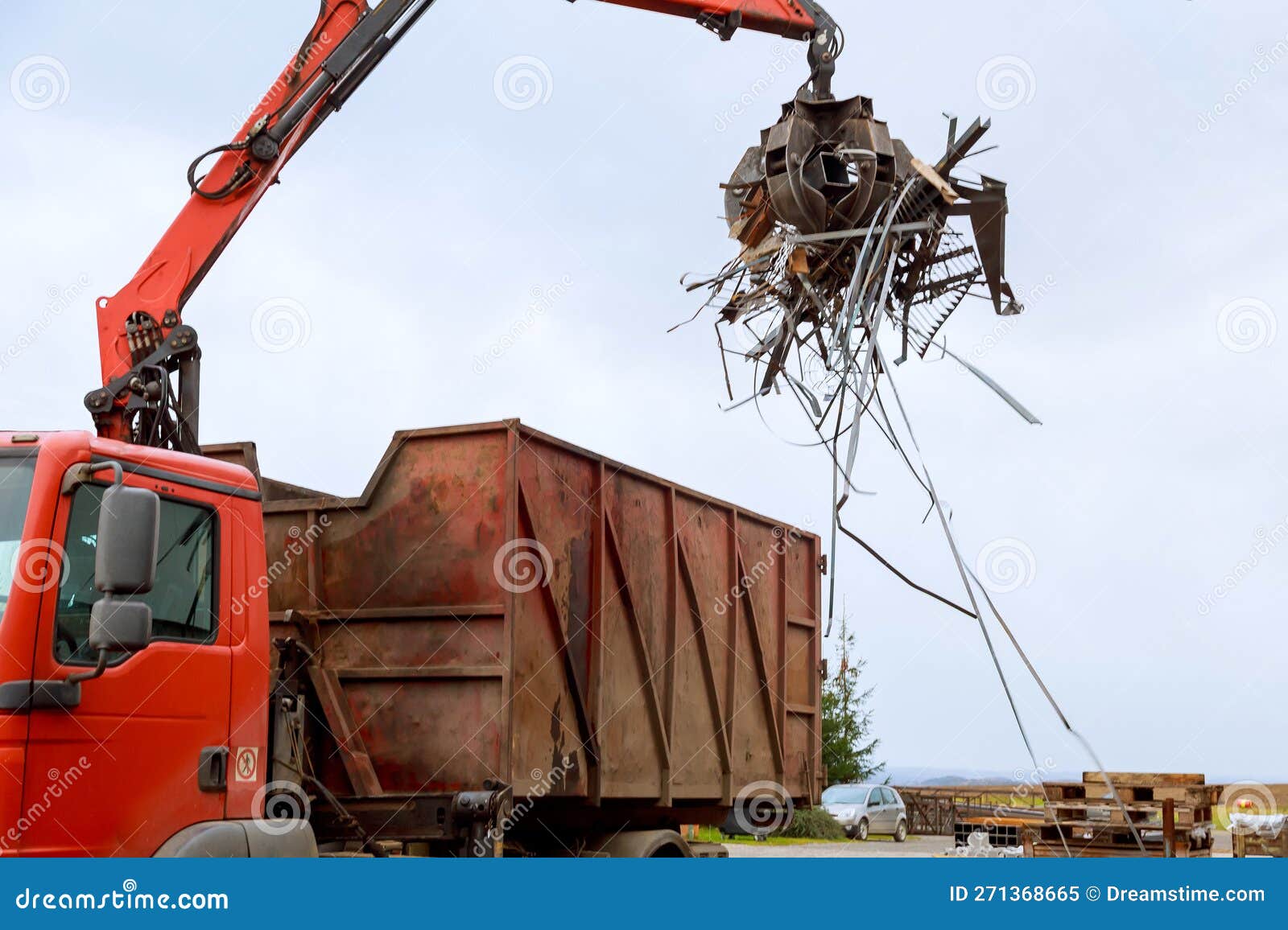 Loading Scrap Metal into a Truck. Crane Grabber Loading Metal Rusty