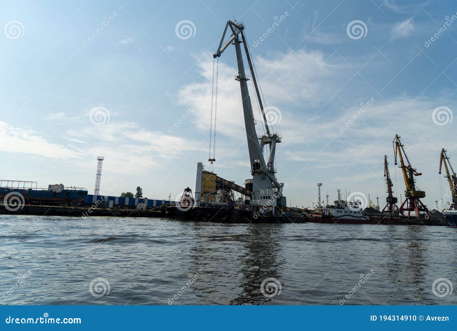 Loading and Unloading Crane Mounted on a Small Barge Stock Photo