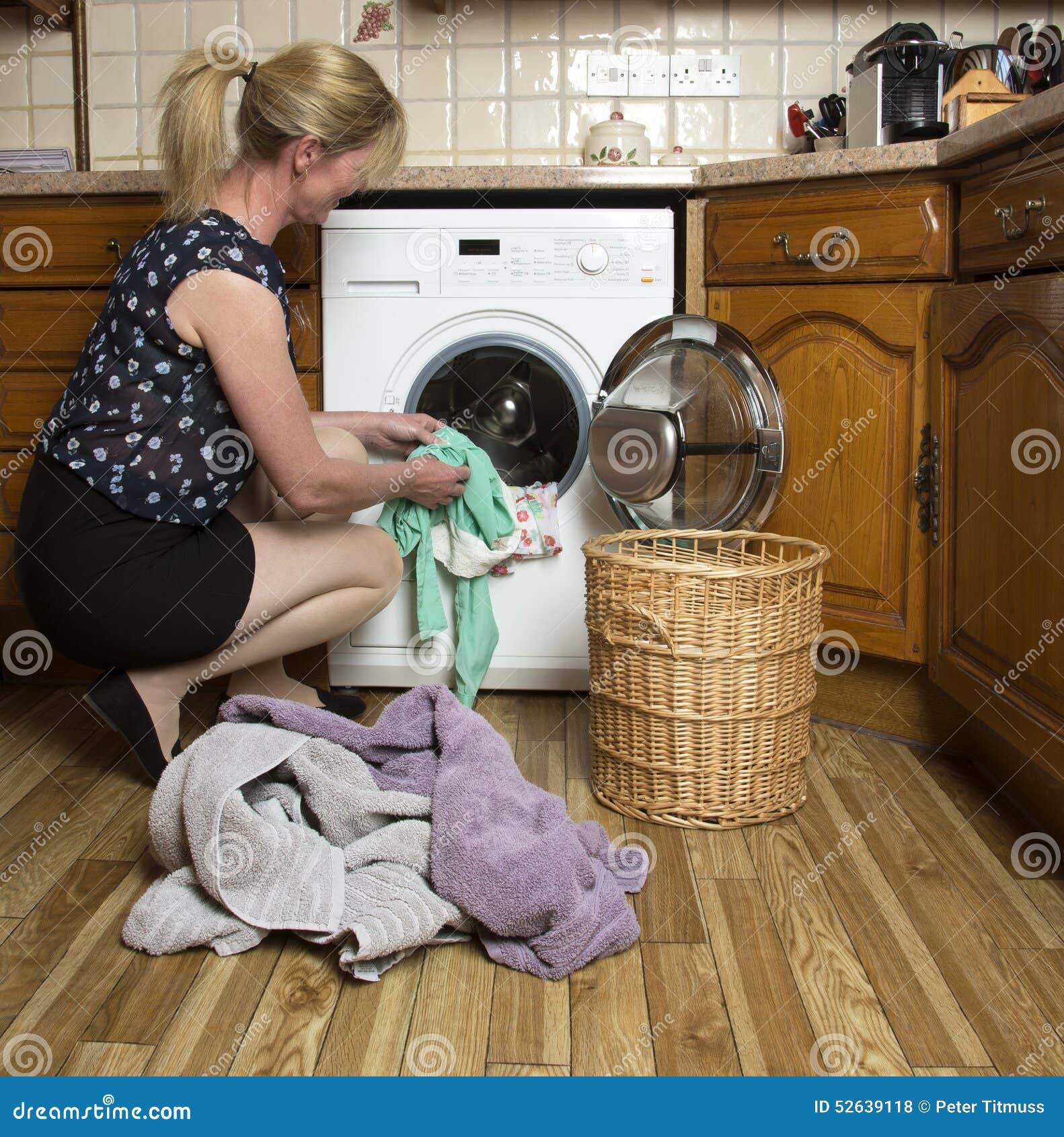 Loading a washing machine stock photo. Image of housewife 52639118