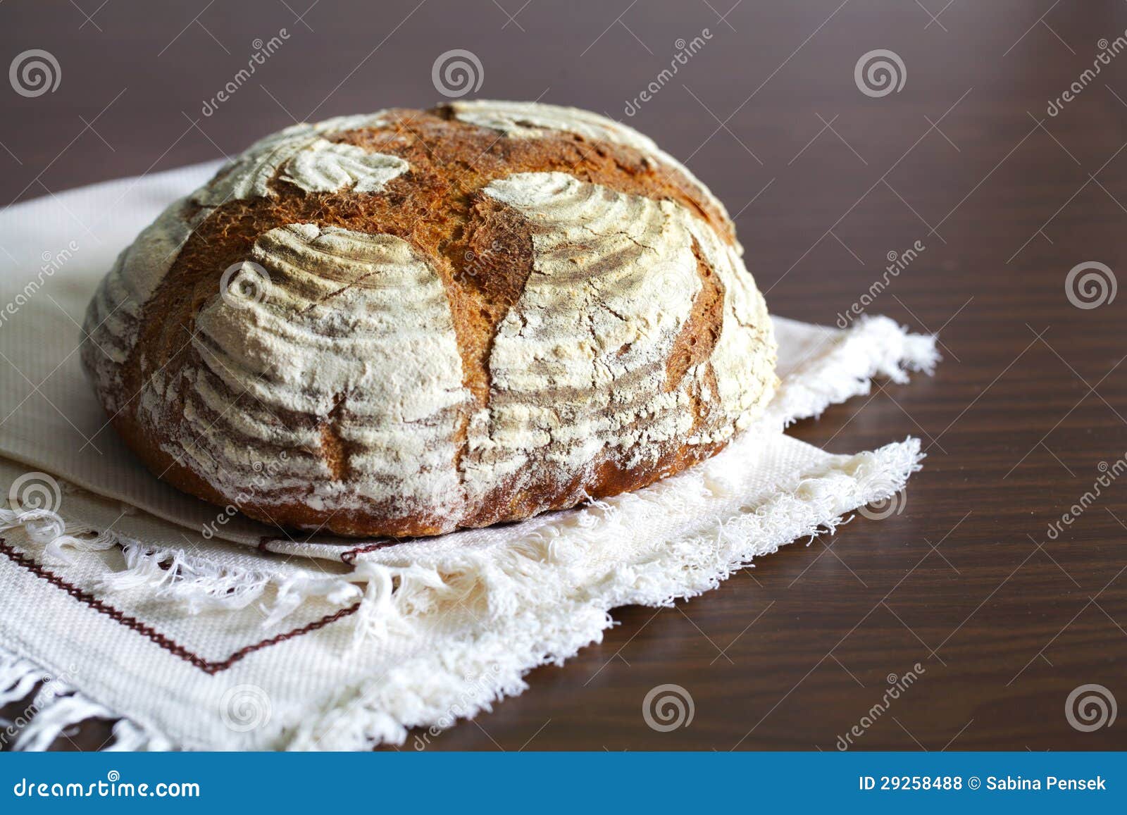 Loaf of Artisan Rye Bread, Dusted with Flour, on a Table Cloth Stock