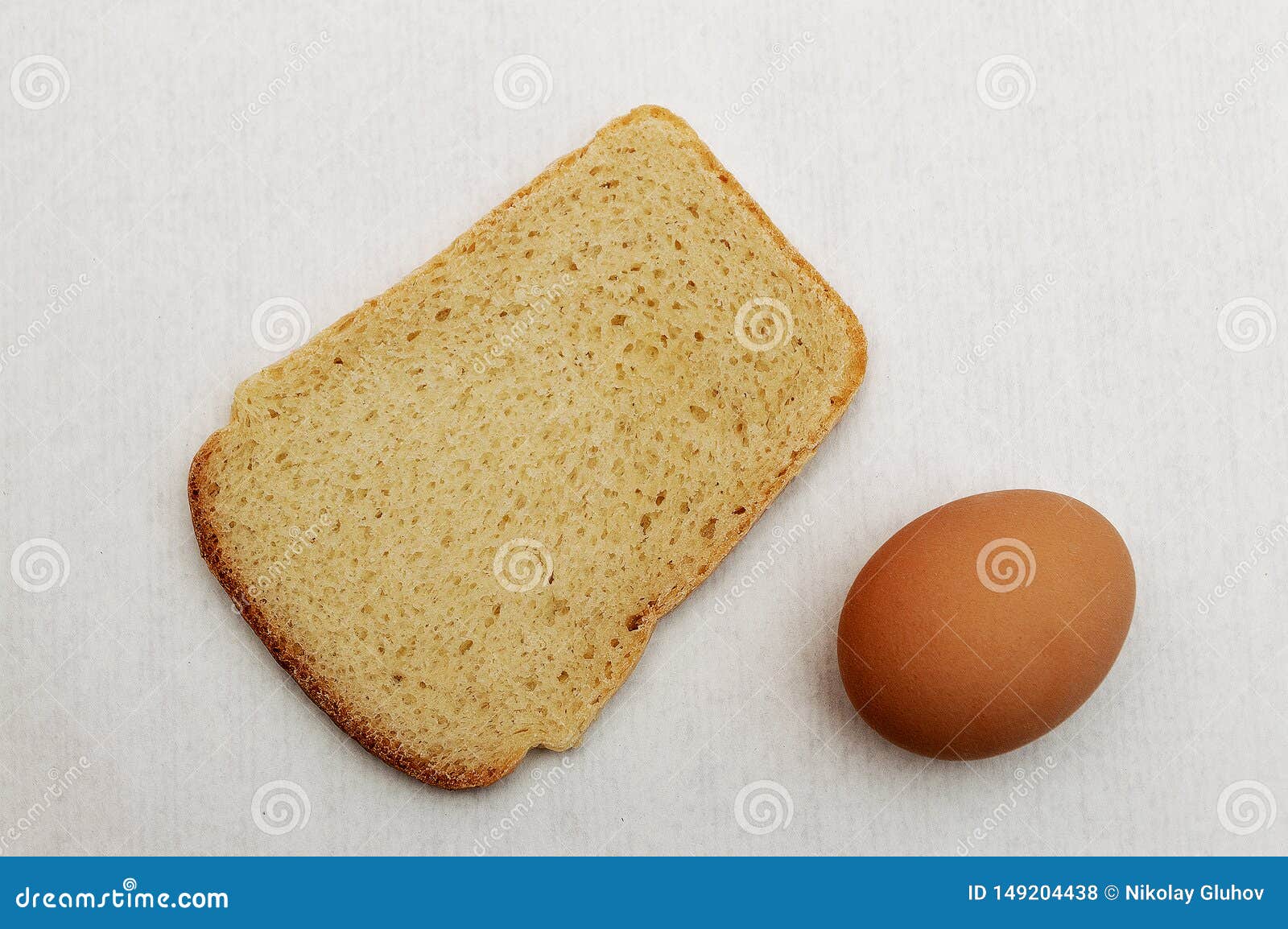 Loaf of Bread and a Brown Egg. Stock Photo - Image of people, grey