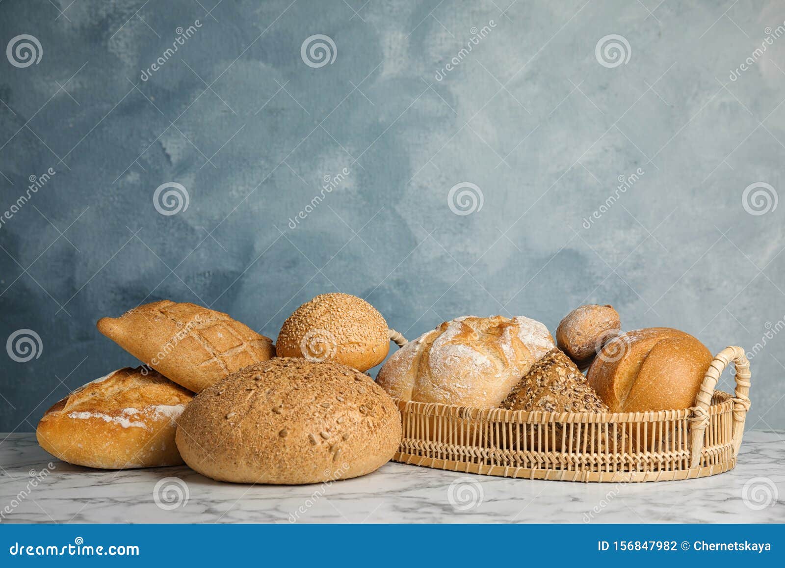 Loaves Of Different Types Of Bread In Wheat Field. Assortment Of Bread