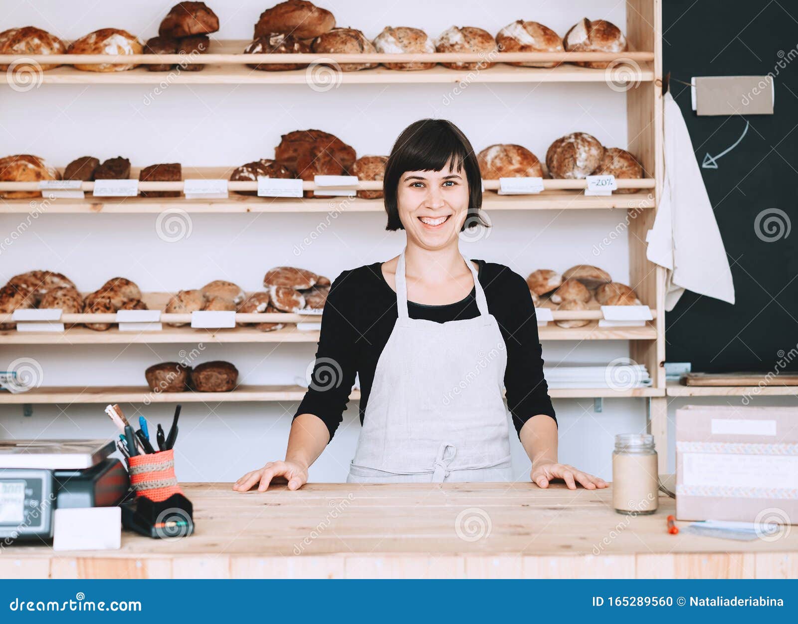 local business owner or bakery worker behind the counter