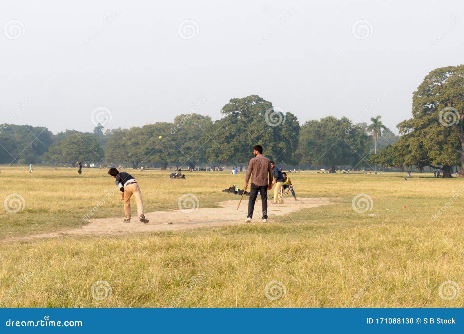Local Indian Boys Having Fun Playing Cricket Game In Maidan Area