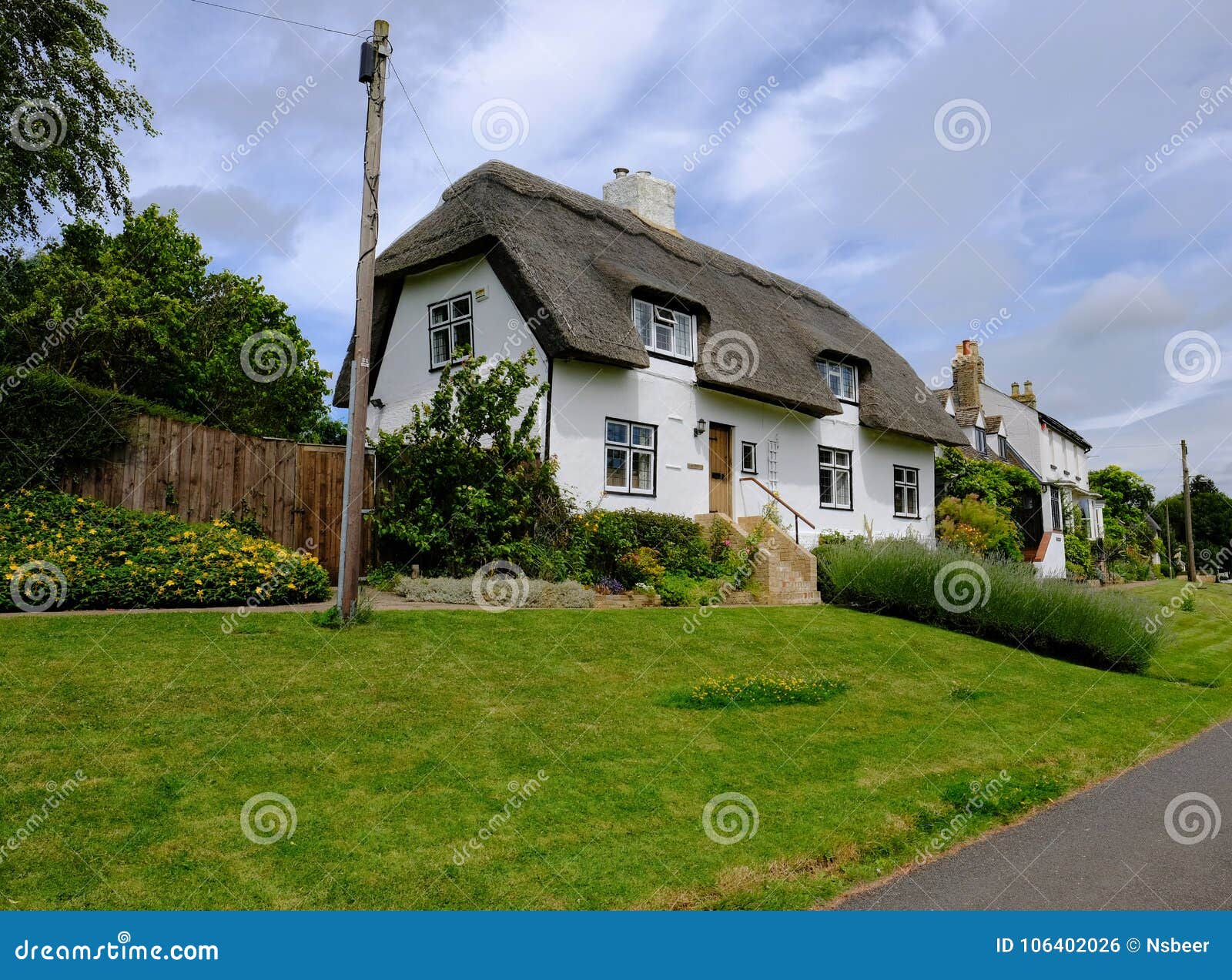 View Of A Traditional English Cottage And Thatched Roof With A