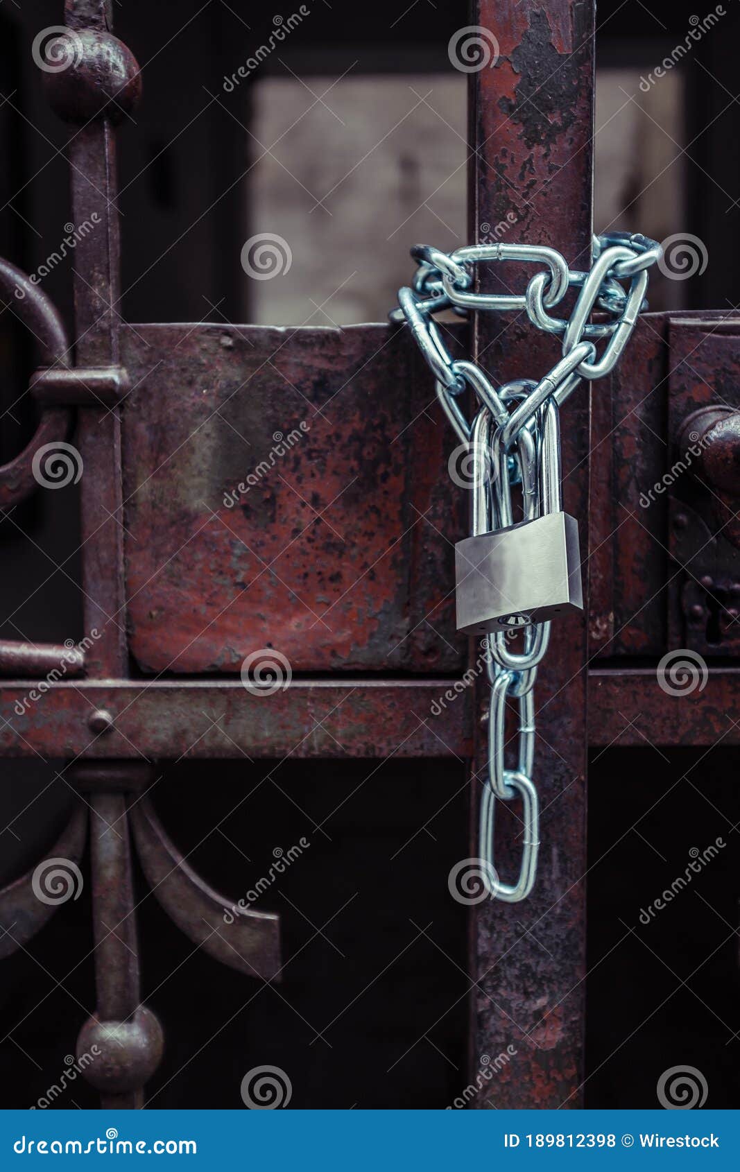 Lock Attached To a Chain Keeping the Metal Gates Closed Stock Photo