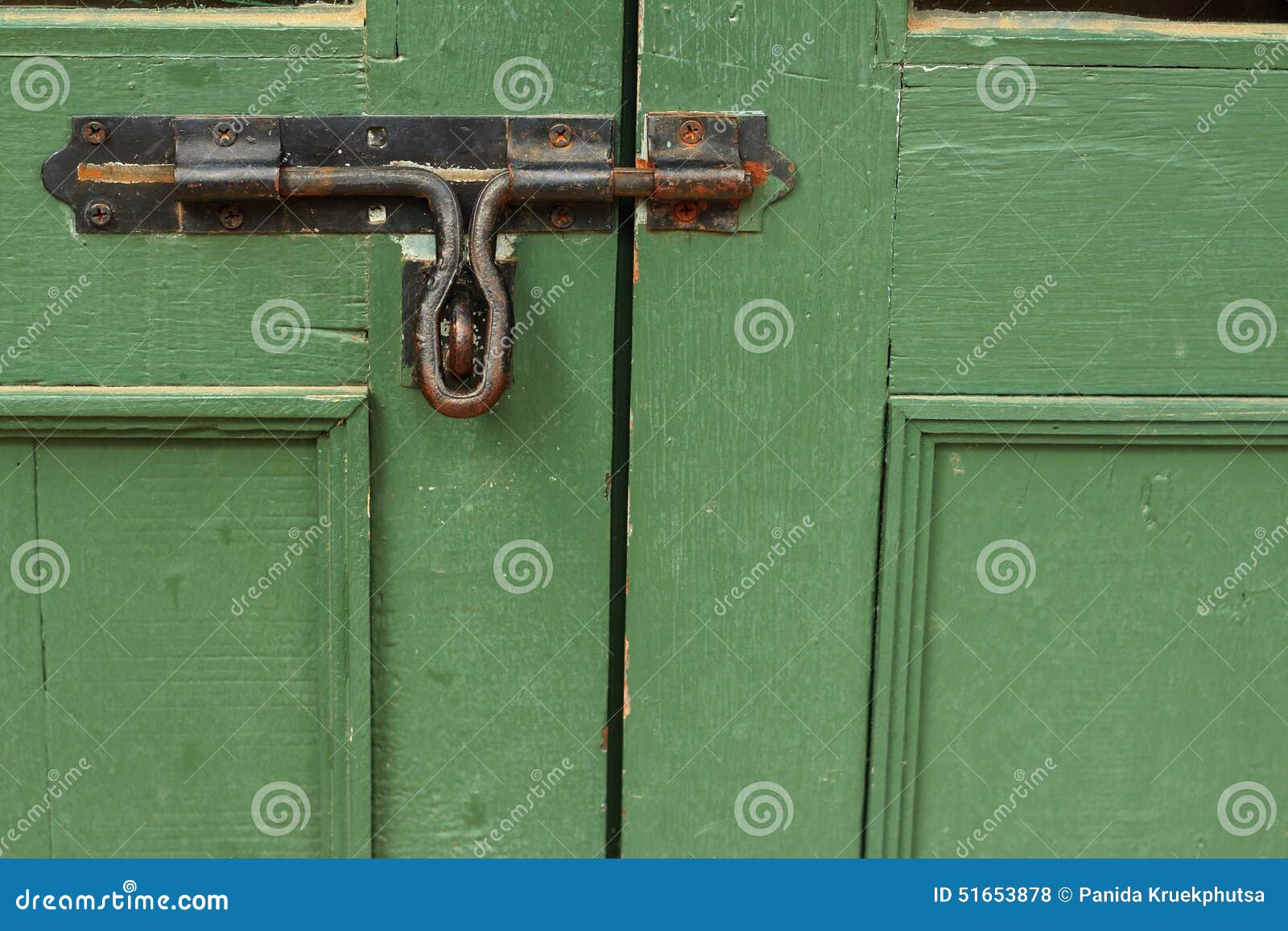 Lock of the door locked with padlock.