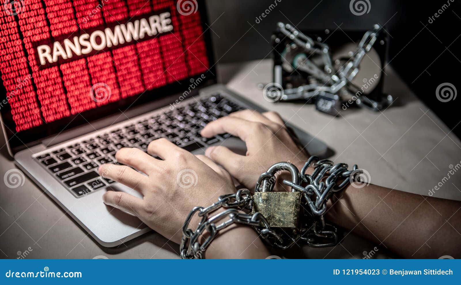 locked hands and ransomware cyber attack on laptop