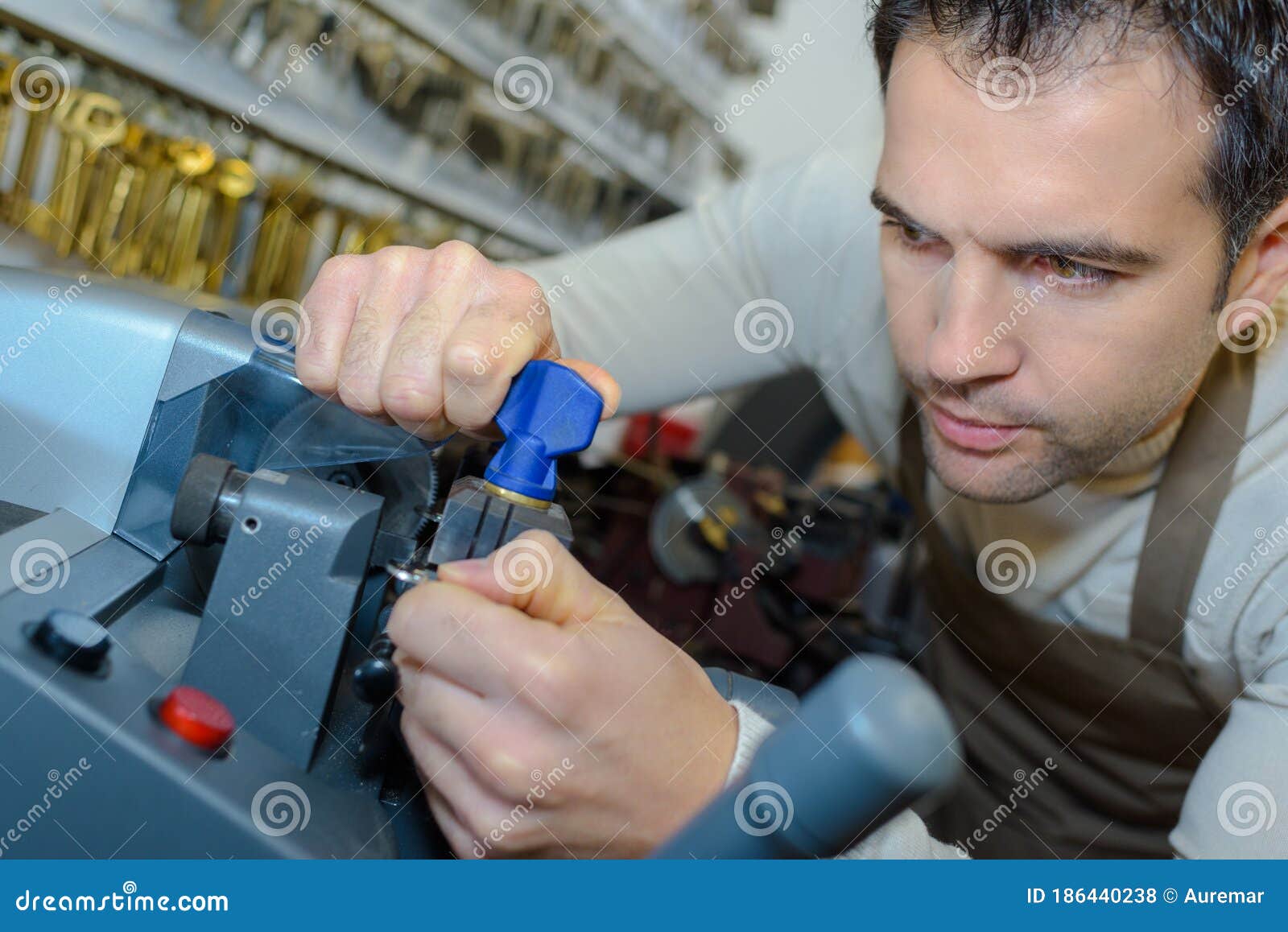 Locksmith cutting new key stock photo. Image of worker 186440238