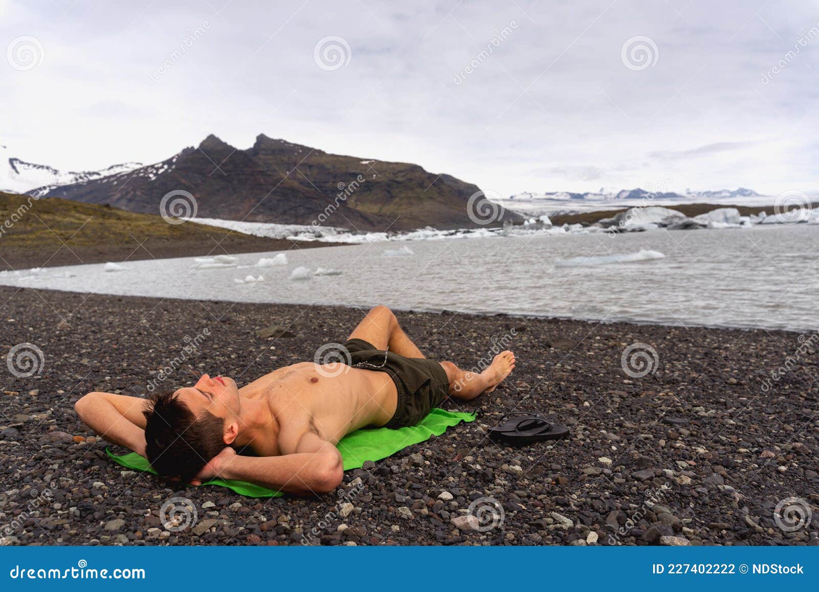 Loco Soñando Con Un Verano Caliente. Tomar El Sol En El Frío Clima De Islandia. Glaciar En El Fondo Foto de archivo Imagen de loco, lago: 227402222