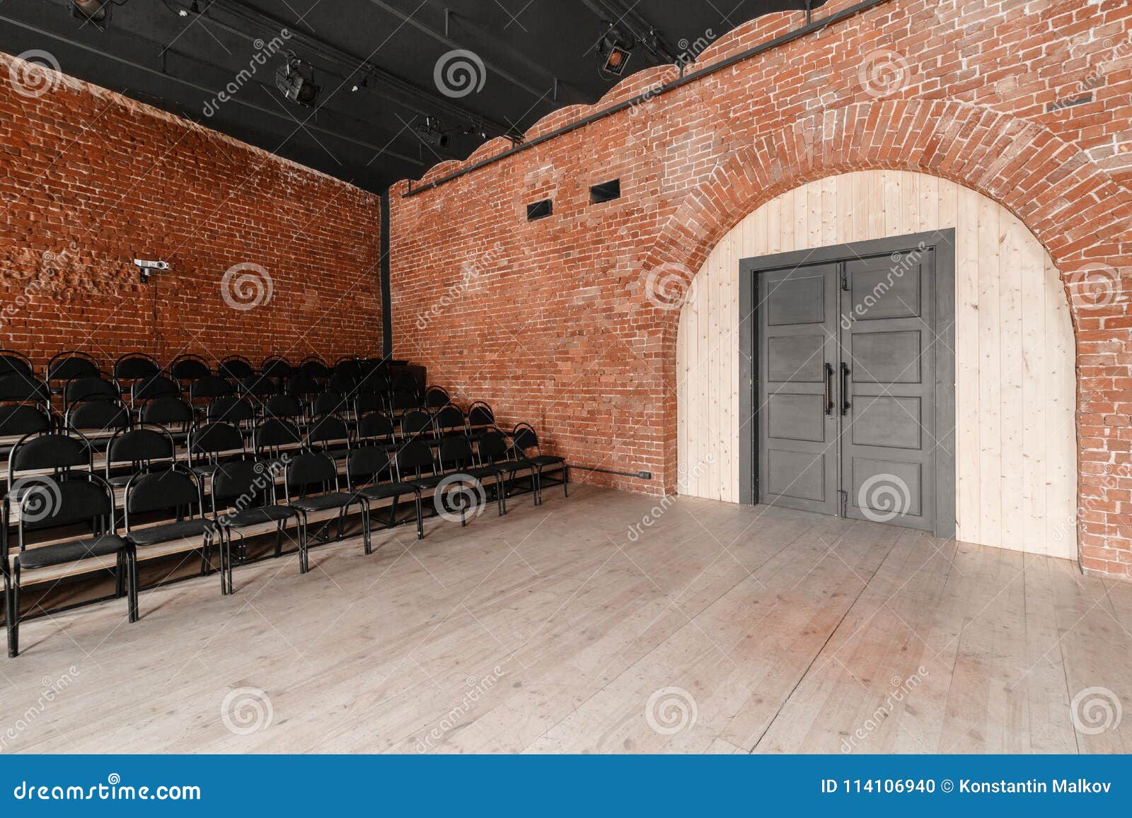 Large Door. Loft Style. Hall With Black Chairs For