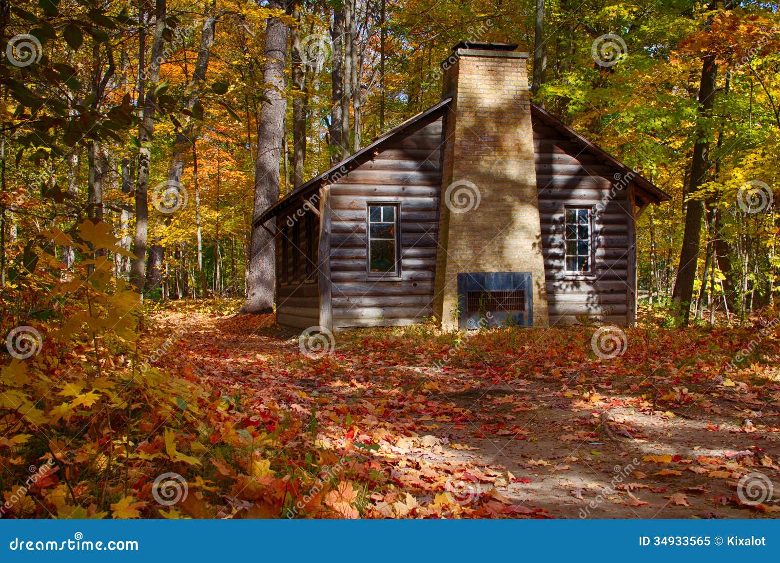 log cabin in fall woods