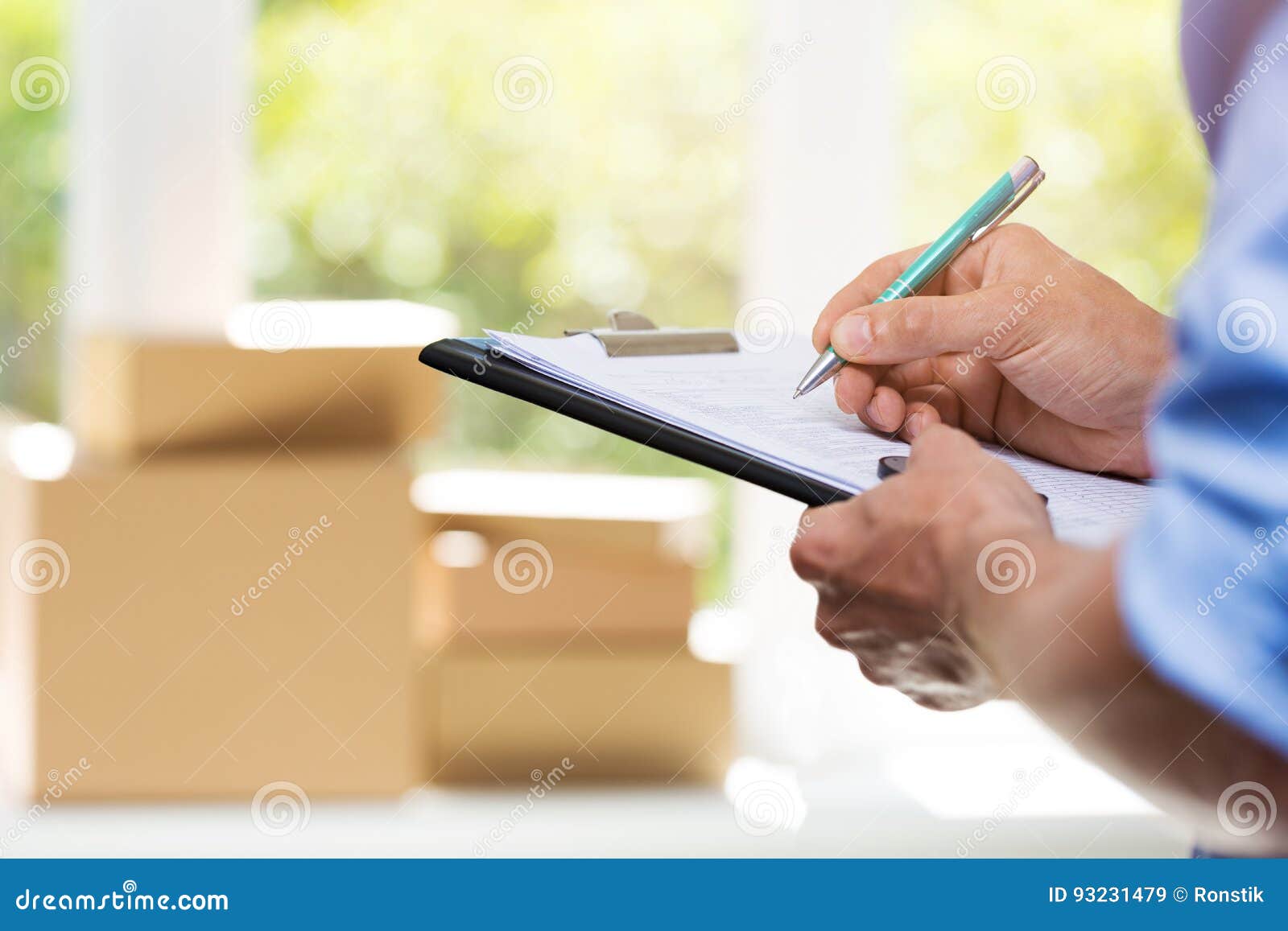 logistics - delivery service man writing documents