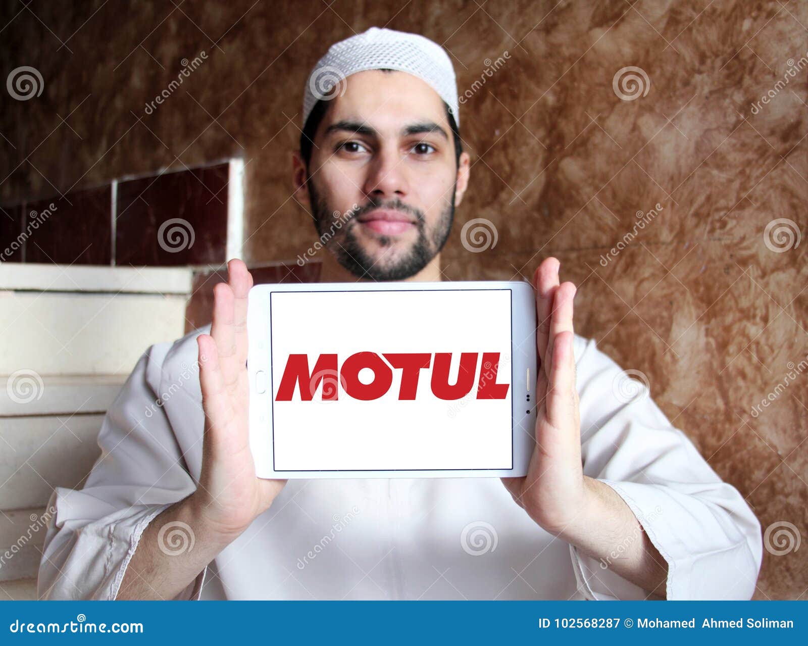 Il logo della società di Motul sulla compressa di Samsung holded dall'uomo musulmano arabo Motul è una società francese globale che i produttori, sviluppa e distribuisce i lubrificanti per i motocicli dei motori, le automobili ed altri veicoli e per l'industria