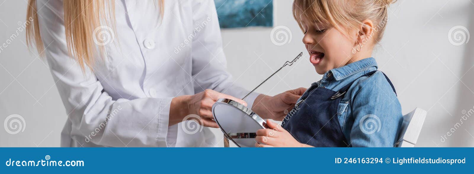 logopedist in white coat holding tool