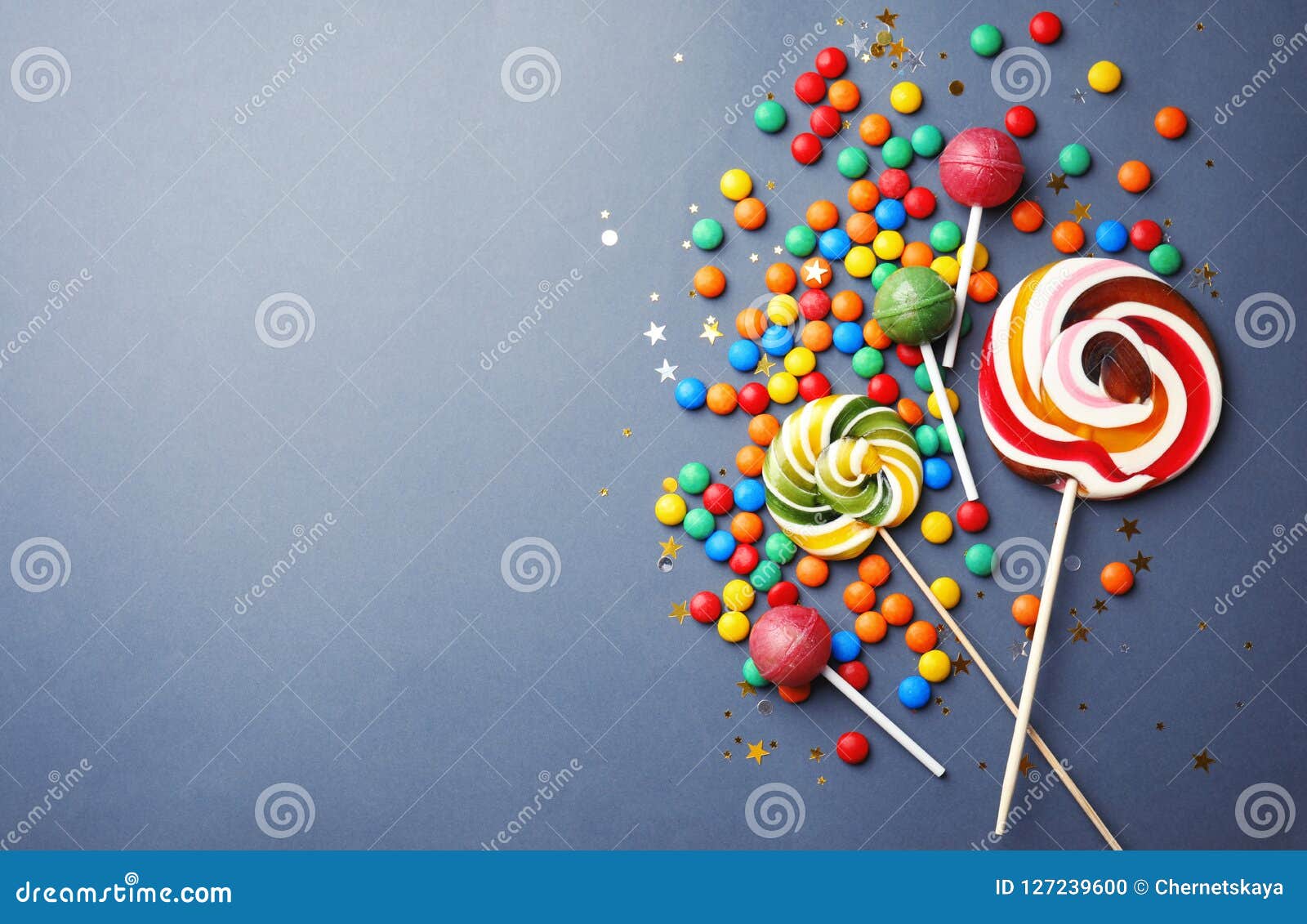 Lollipops and Colorful Candies on Grey Background, Top View Stock Photo ...