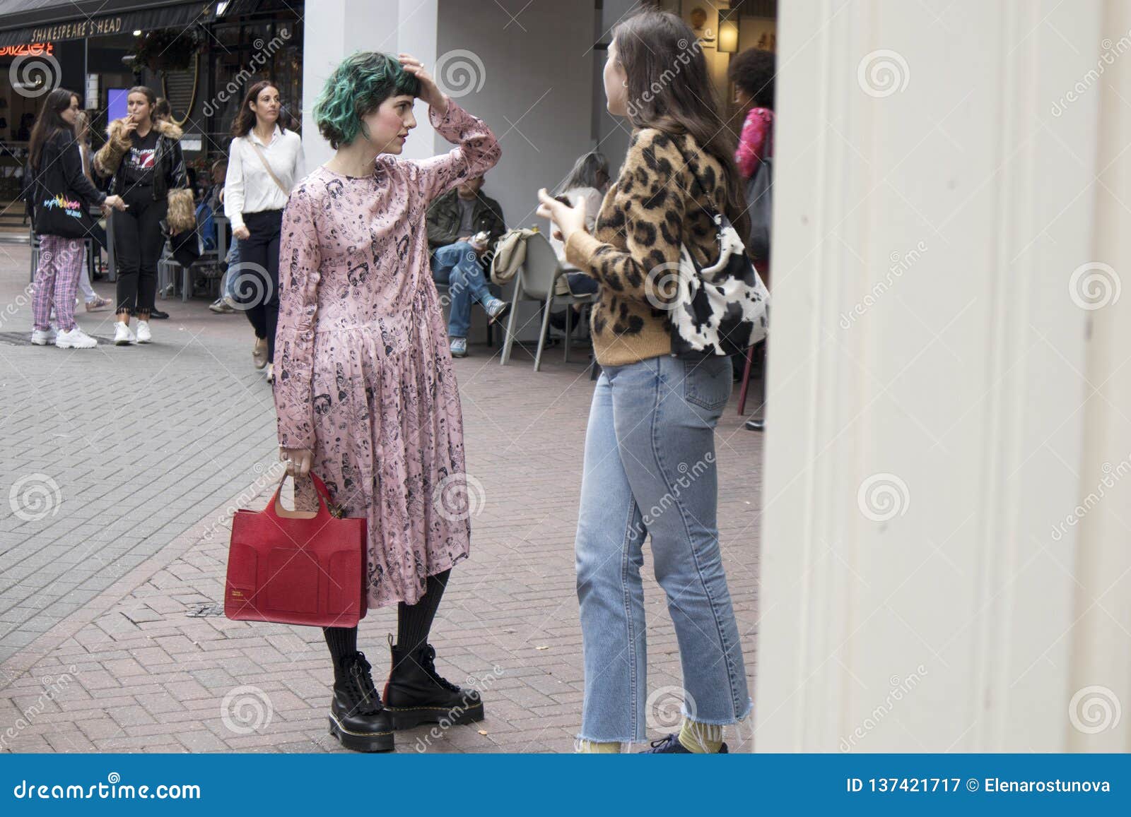 Two Fashionable Girls Talking While Walking Editorial Photography