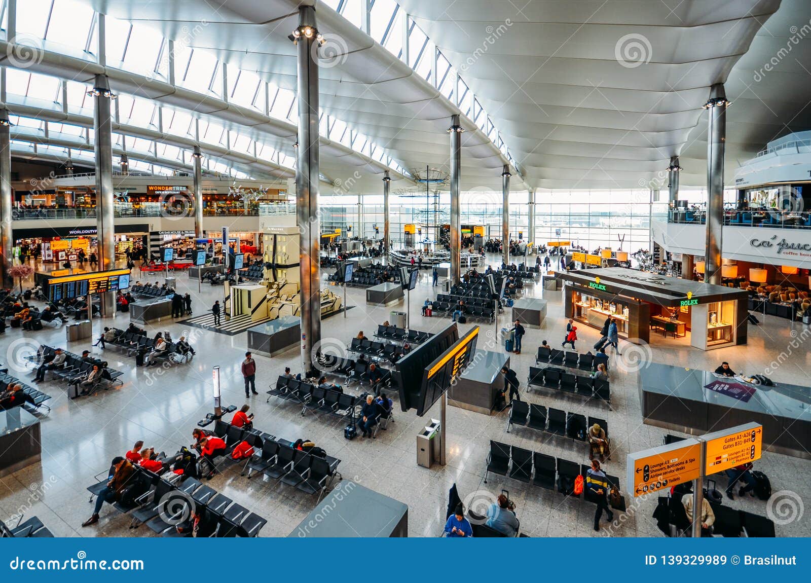 High Perspective View Of Passengers And Shops At Departure Terminal At