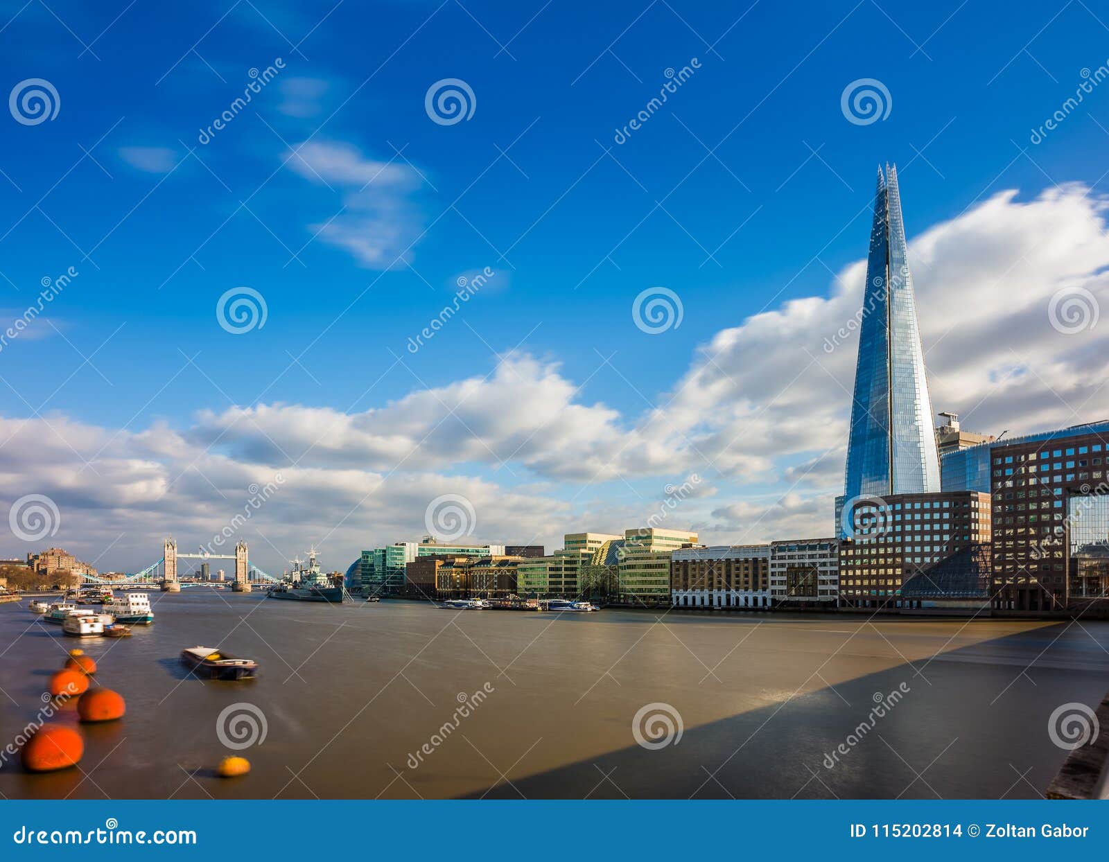 london, england - the shard, london`s highest skyscraper with the iconic tower bridge at background