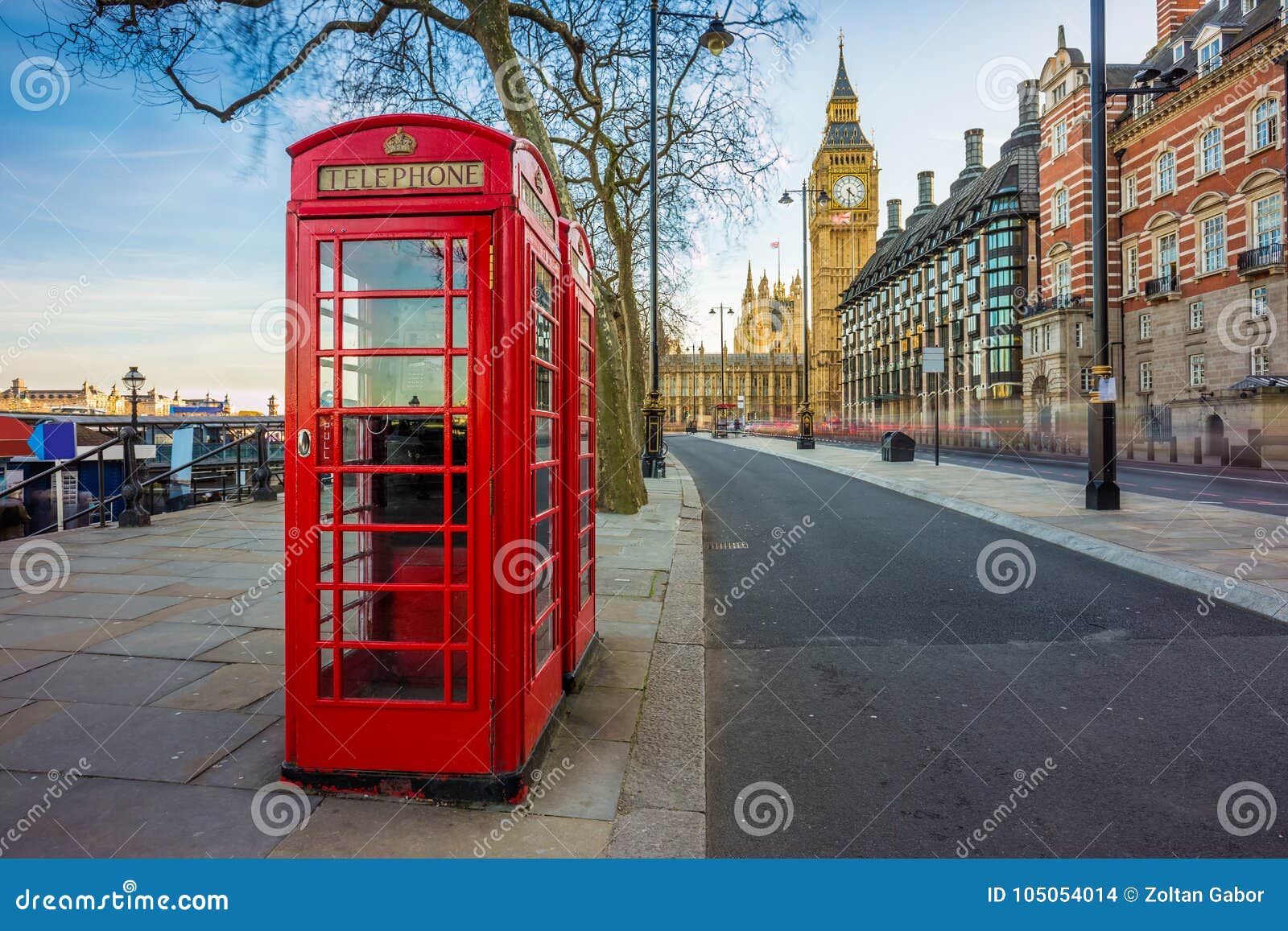 london, england - traditional old british red telephone box at victoria embankment with big ben