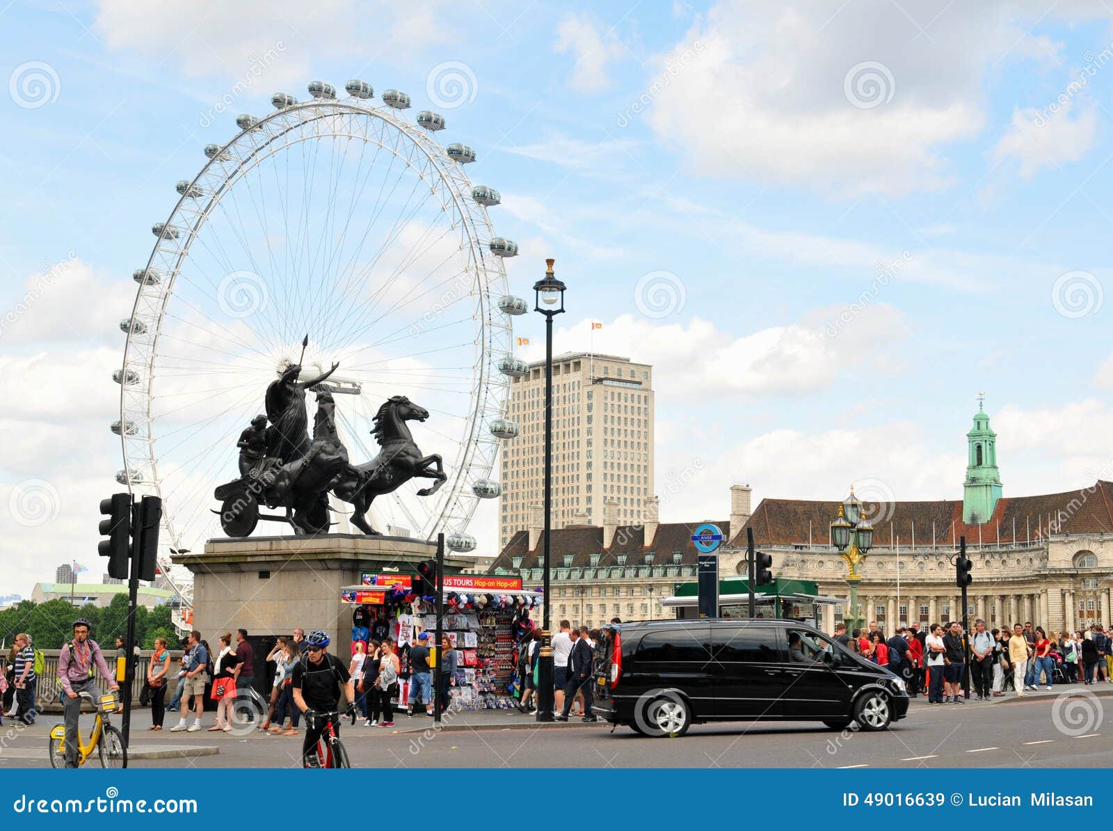 London tourists. LONDON, UK - JULY 9, 2014: Tourists admire the London skyline from the Westminster bridge in central London.