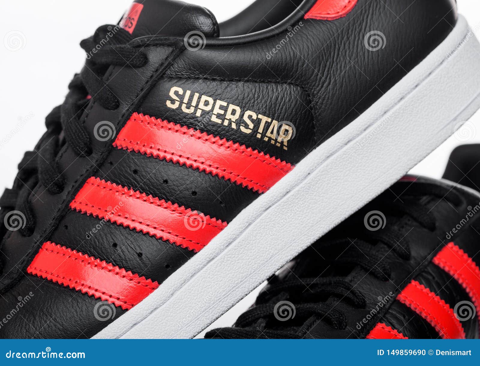 black adidas shoes with red stripes