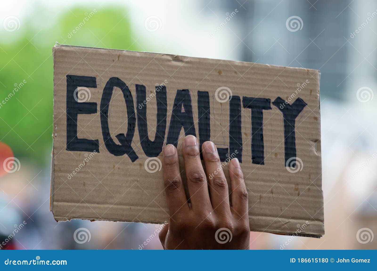 protesters holding sign at black lives matter protest demonstration in london.