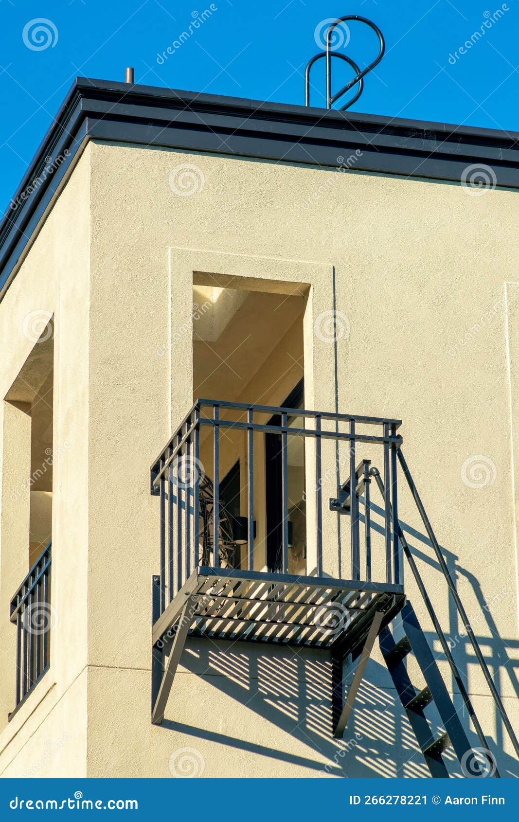 Lone Balcony with Fire Escape Ladder and Rooftop Access with Beige