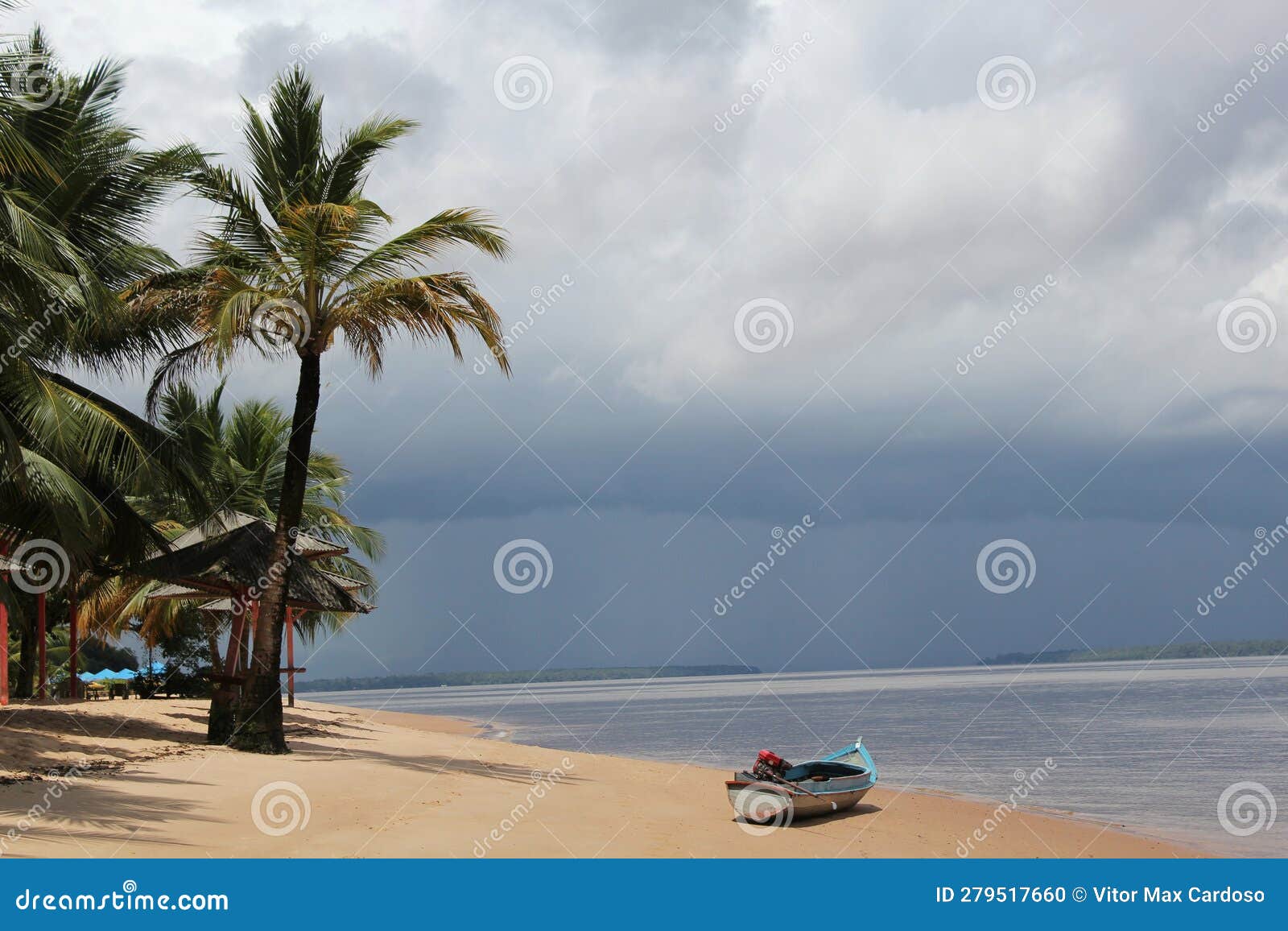 a lone boat rests on the sands of a river beach