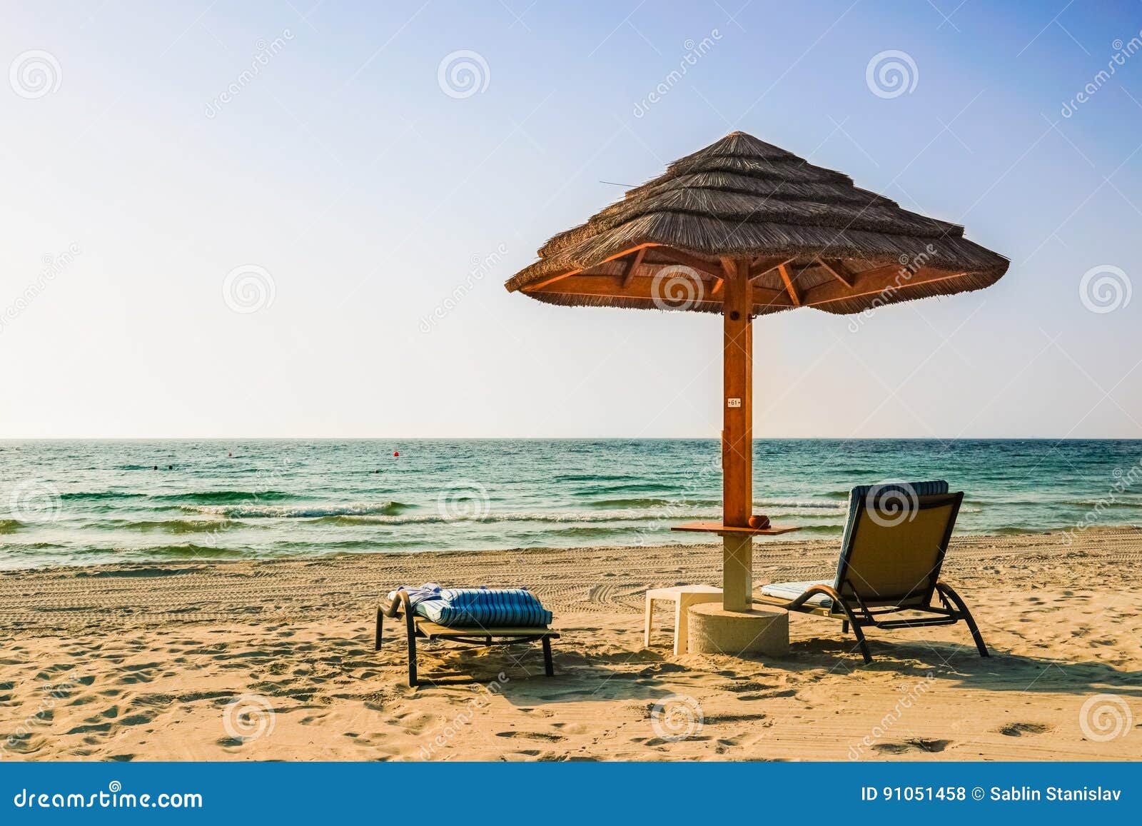 A Lone Umbrella on the Beach of the Arabian Gulf in Dubai. Summer 2016