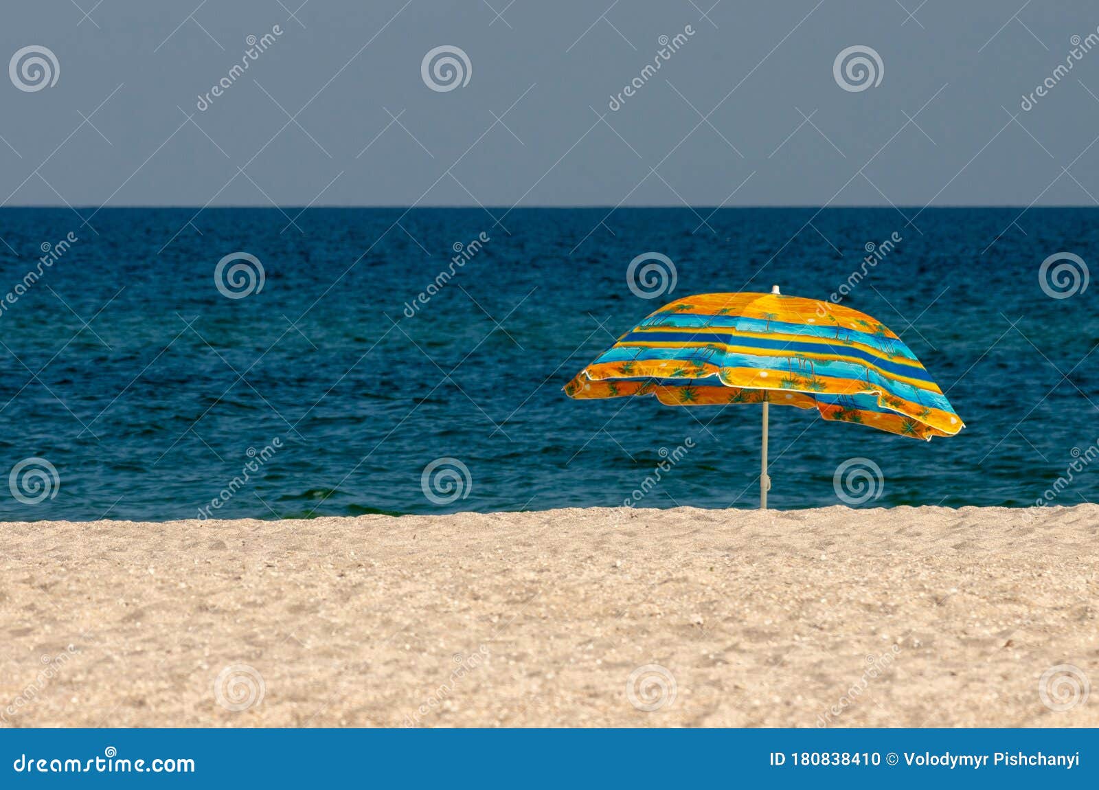 Lonely Beach Umbrella on a Deserted Sea Beach Stock Photo - Image of ...
