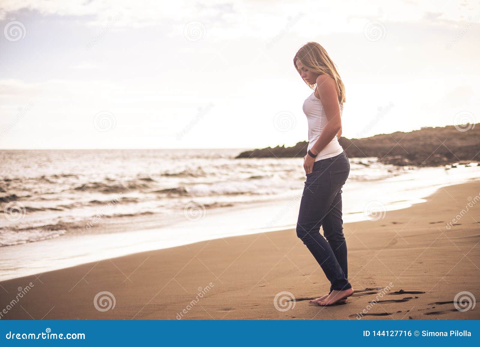 Lonely Beautiful Blonde Young Woman Walking on the Shore with Nude Feet on  the Sand at the Beach Relaxing and Enjoying the Ocean Stock Photo - Image  of enjoy, attractive: 144127716