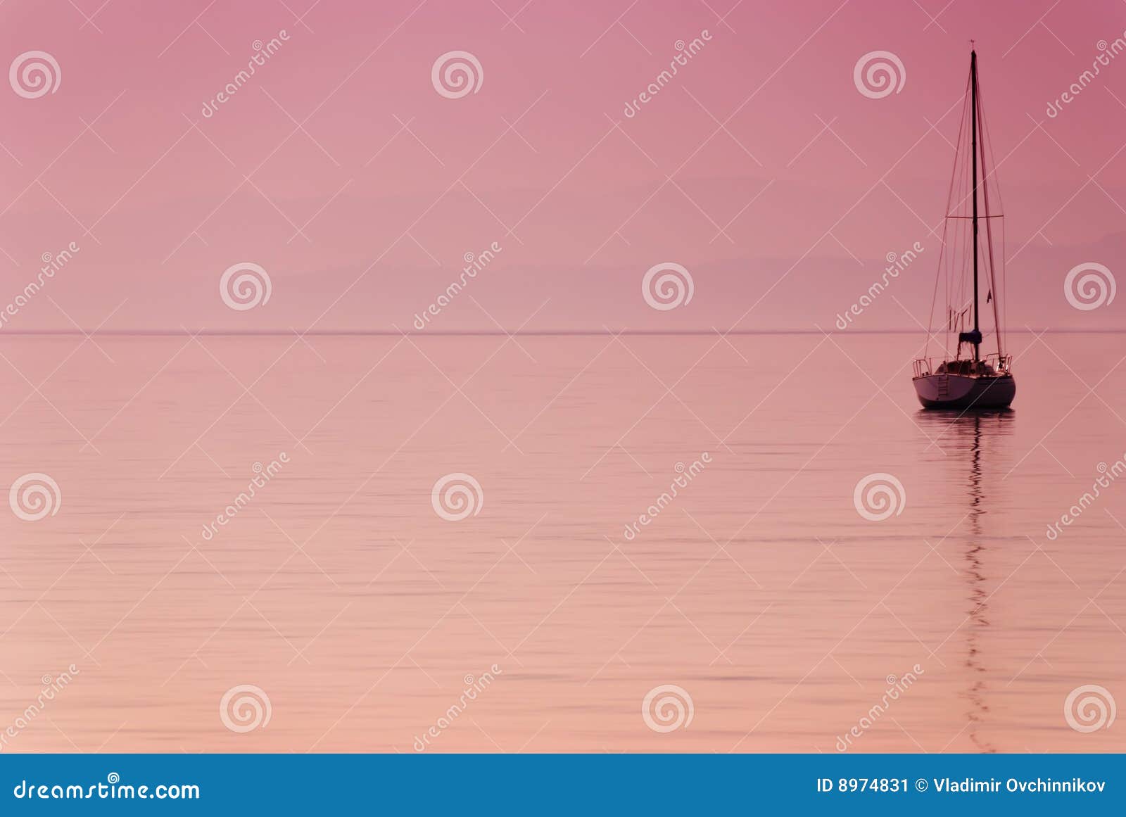 Lonely boat against lake in lilac tones at dawn.