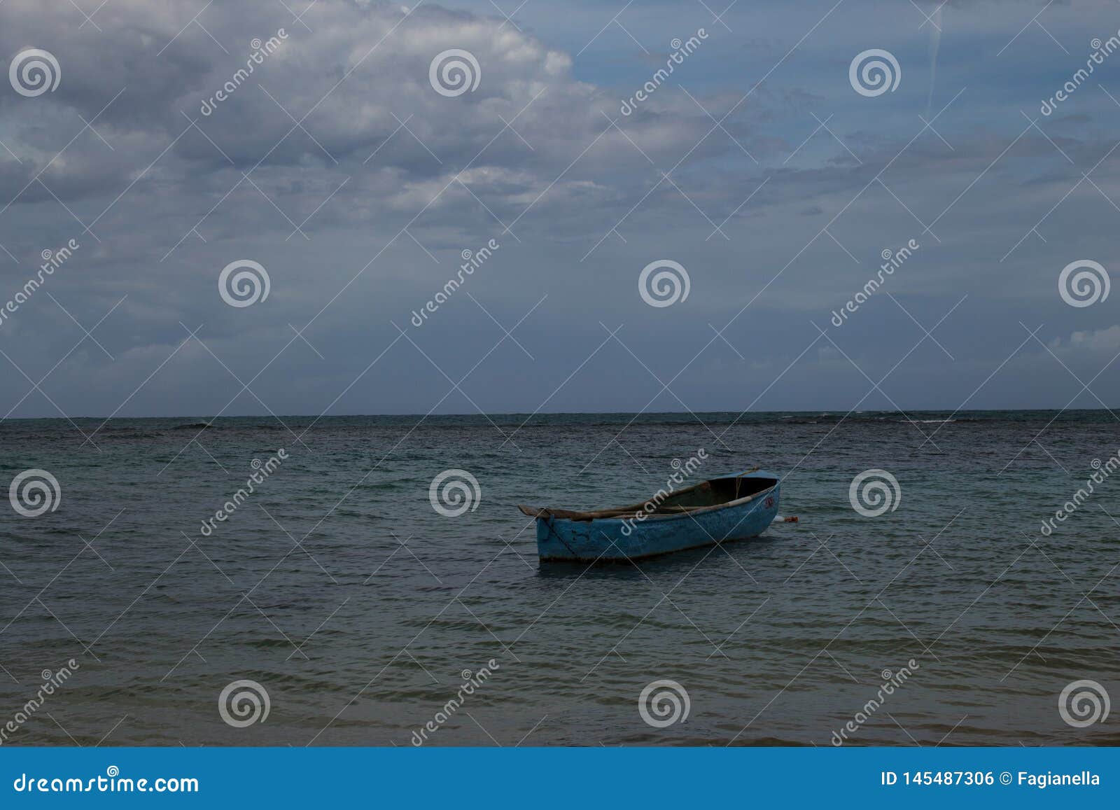 a lonely boat in the sea in playa ballenas, las terrenas, dominican republic