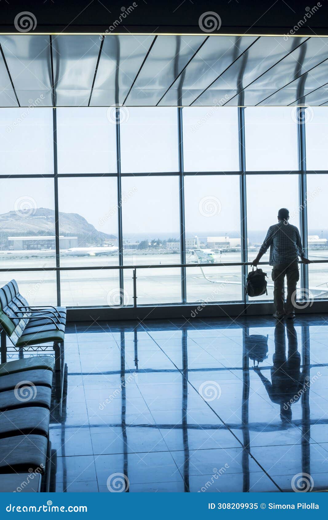 lonely business man travel and wait at the airport gate - concept of delay and cancel filght problem and passenger rights - people