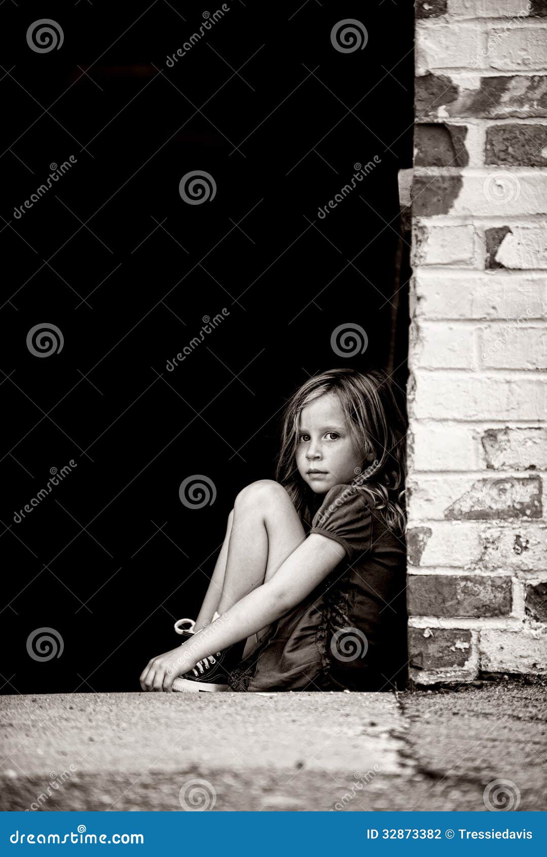 sad little girl sitting alone