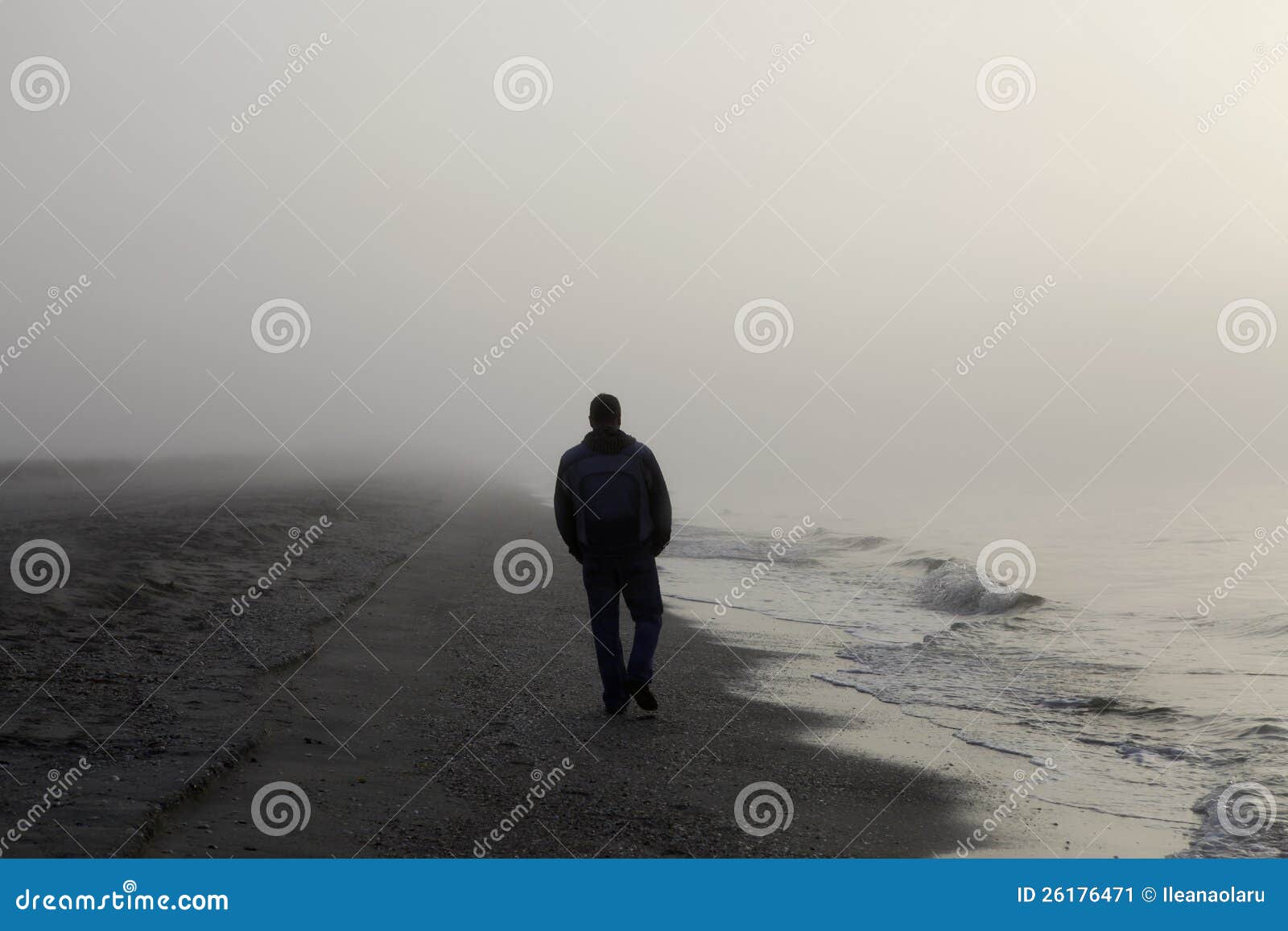 lonely man walking on a beach