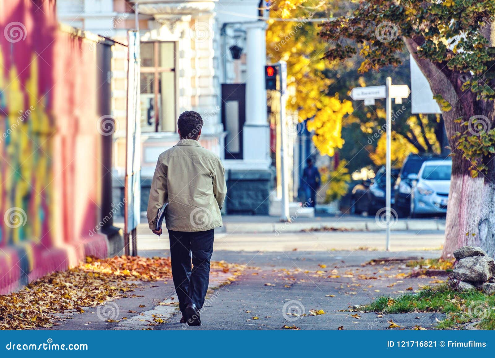 lonely man walking on sergey lazo street with map full of paper