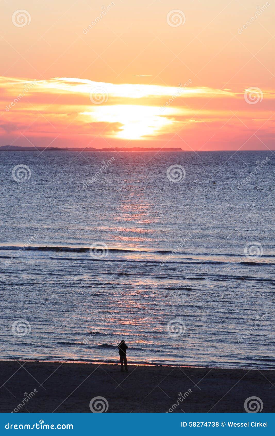 lonely person looking at sunset, dutch ameland island