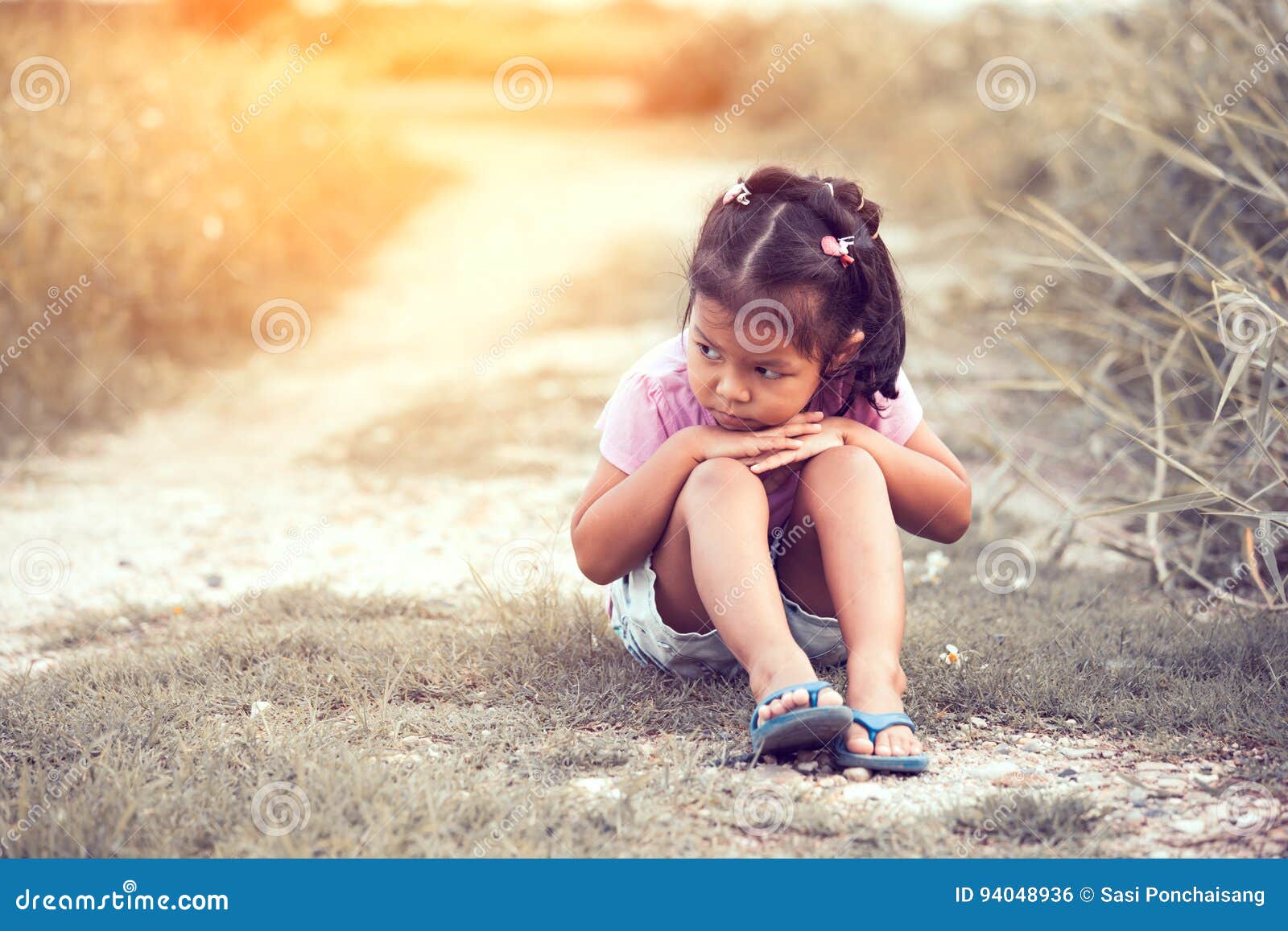 sad little girl sitting alone