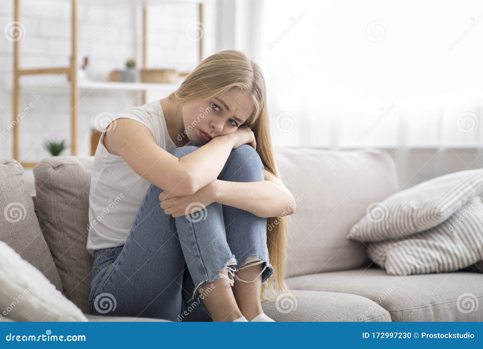 Lonely Sad Girl Sitting On Couch At Home Alone Stock Photo Image O