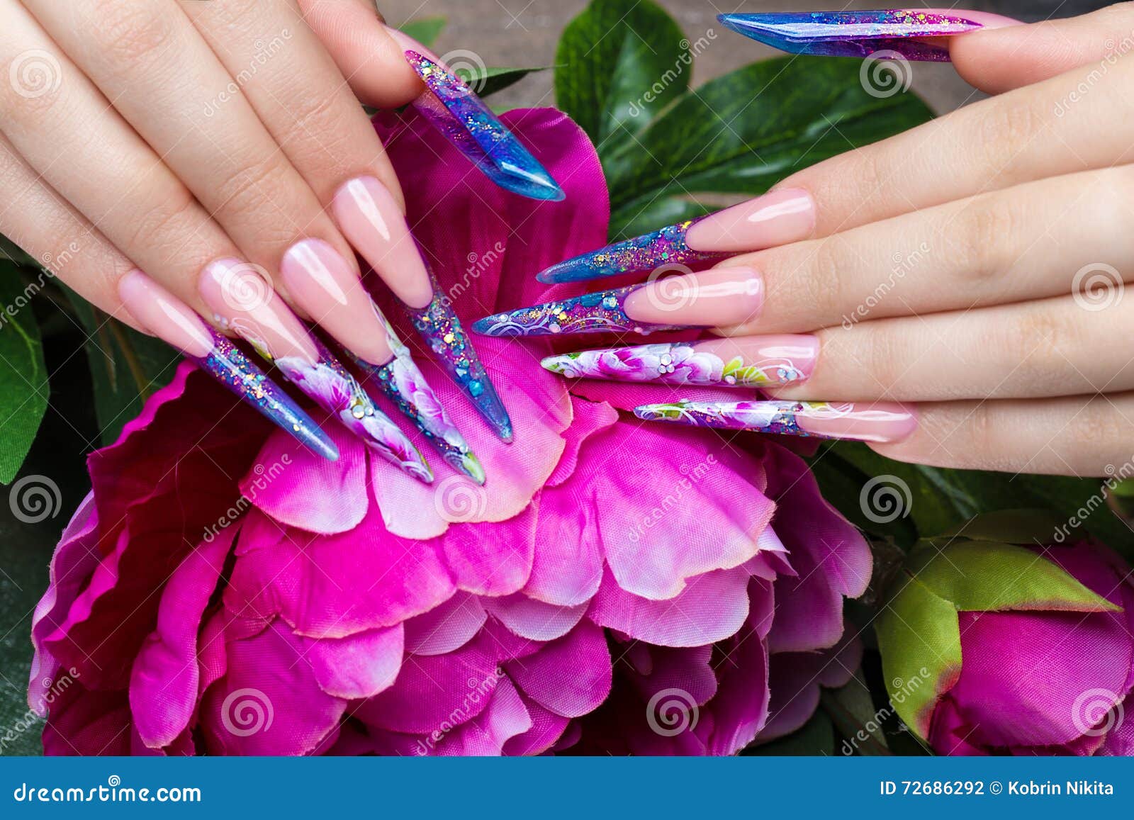 long beautiful manicure with flowers on female fingers. nails . close-up