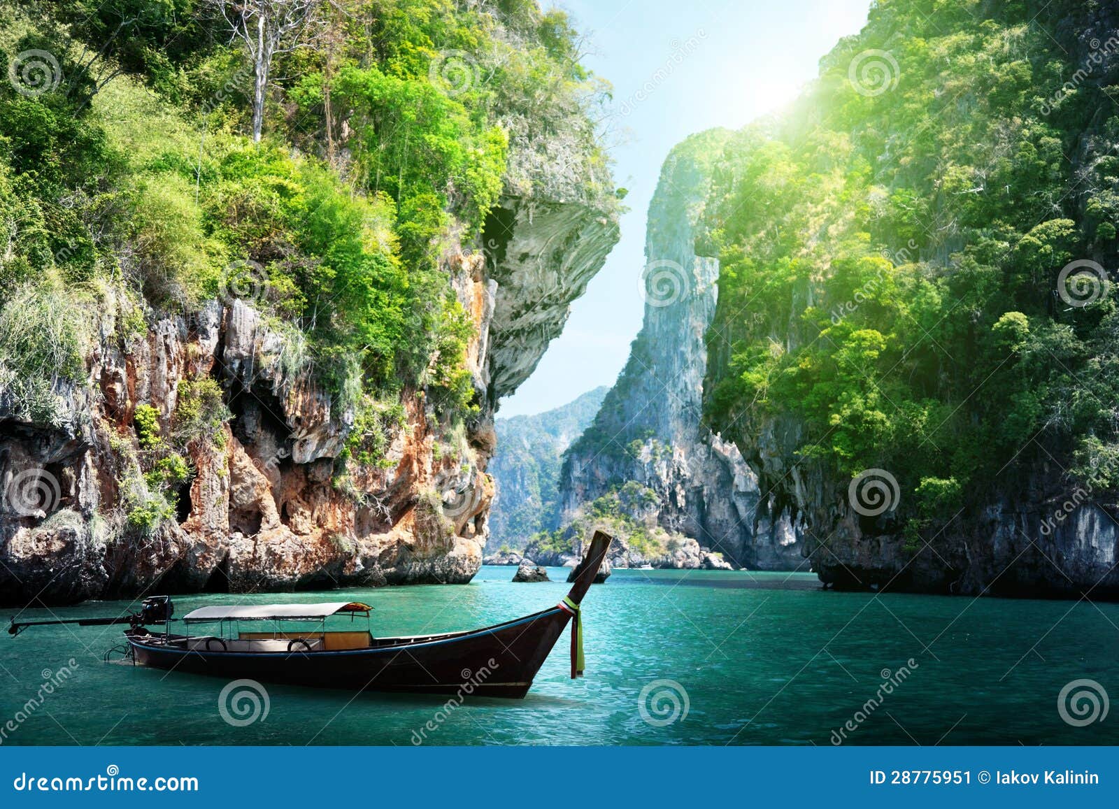 long boat and rocks on railay beach in thailand