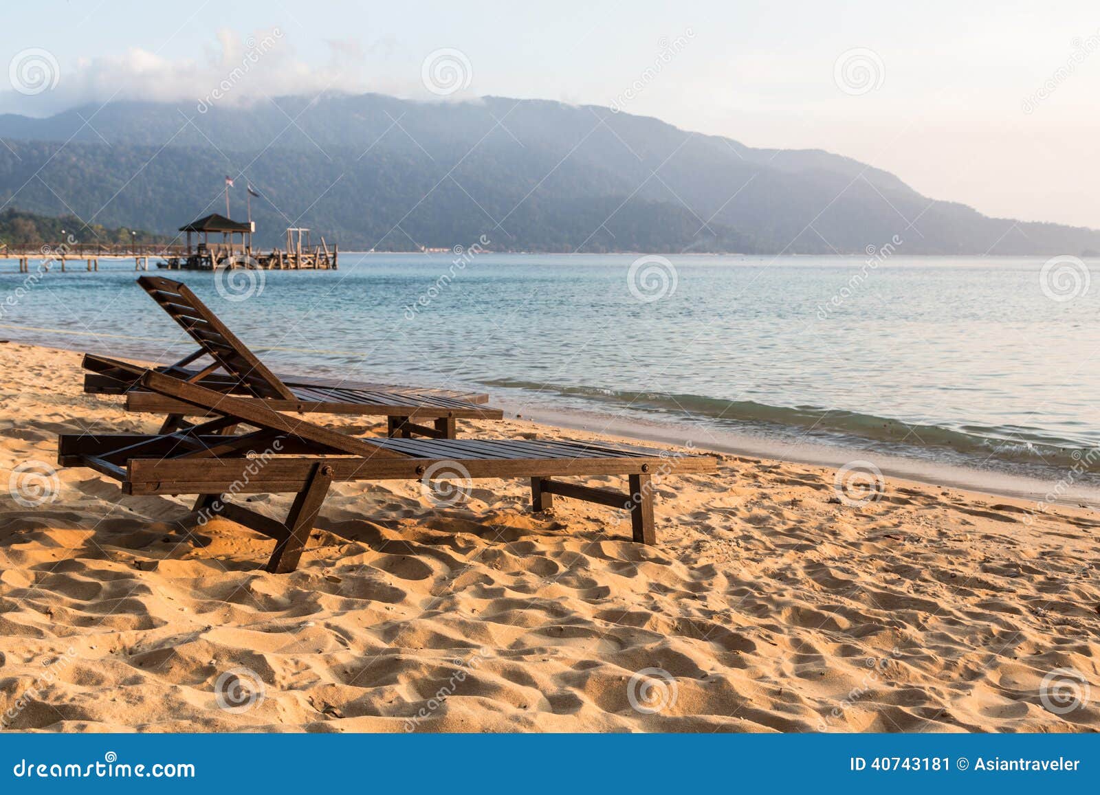 long chairs on a beach in pulau tioman, malaysia